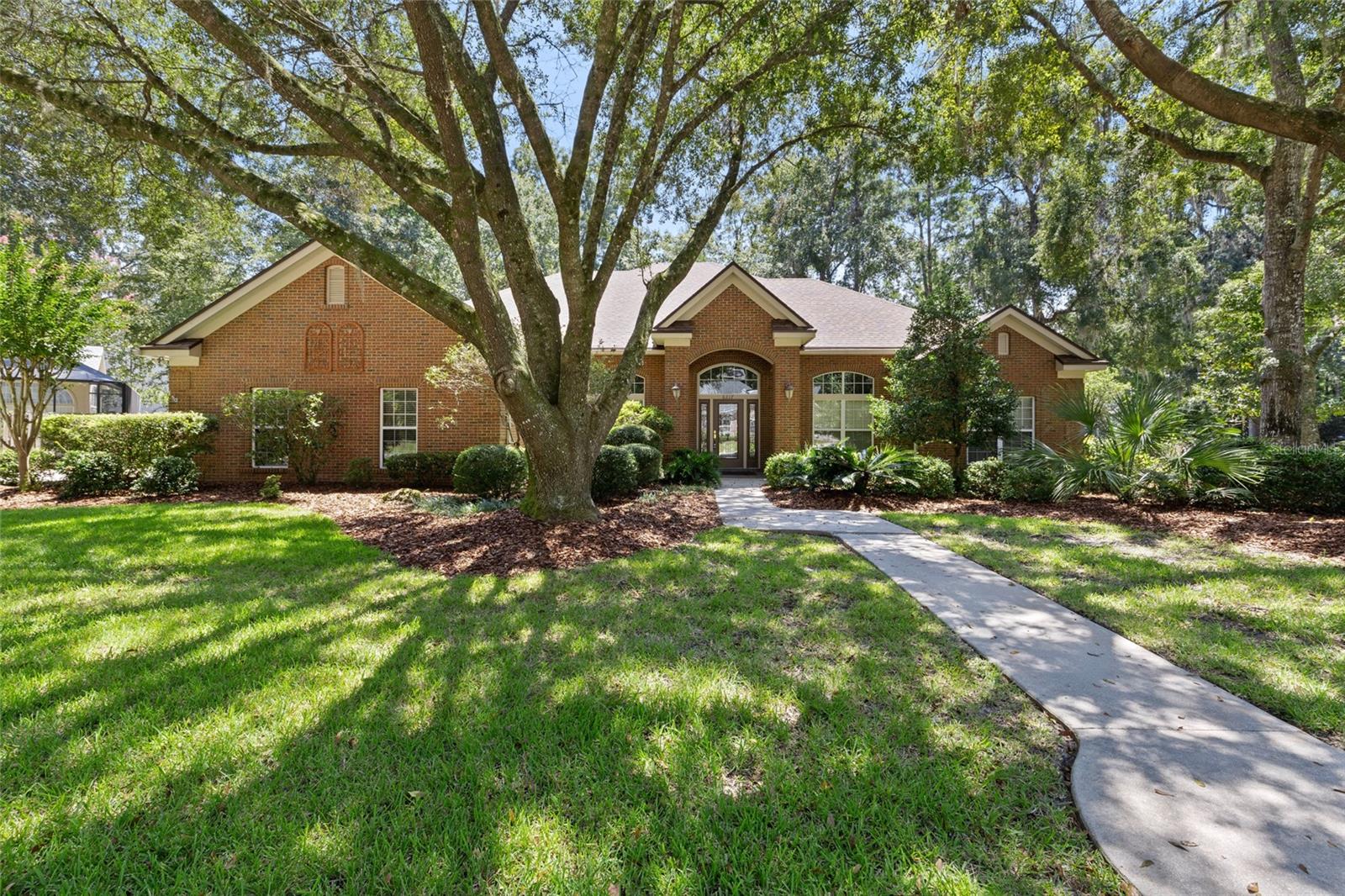 Beautiful brick home in gated Windsor Glen, off of scenic NW Millhopper Road. Step into this open and bright home featuring 3 bedrooms, 2.5 bathrooms and TWO offices. Wood flooring throughout the main areas with tons of natural light. Large family room features built-ins for storage and opens to the kitchen with gorgeous wood cabinetry, granite counters and eat-in kitchen area. Large formal dining room perfect for entertaining. Guest bedrooms are large with extra-large closets. Luxury primary suite features its own gas fireplace, stunning windows and extra large closet. Primary bath with tub and walk-in shower. Extra large two car garage, and a rear porch with brick accents. BRAND NEW ROOF AUGUST 2025! All of this minutes to I75, NFRMC, UF, and more!