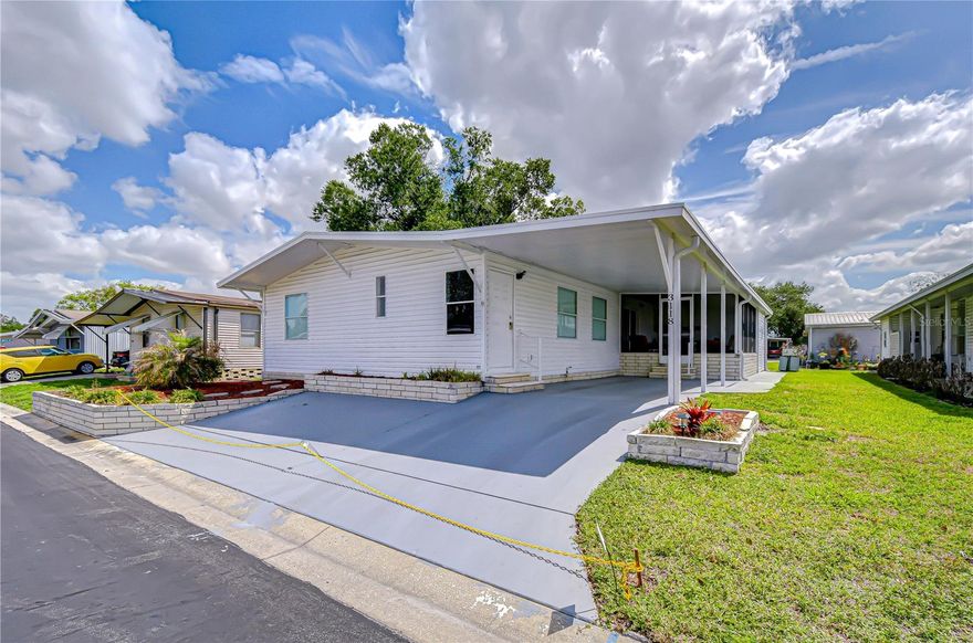 Step into comfort and easy Florida living with this beautifully maintained 3-bedroom, 2-bath split-plan home located in a desirable gated community with NO lot rent. Pride of ownership shines throughout this bright and cheerful residence featuring both a living room and a separate family room for relaxing or entertaining. The updated kitchen offers stainless steel appliances, a convenient snack bar, and flows seamlessly with laminate flooring throughout for a modern, low-maintenance feel, while the spacious primary suite includes a walk-in closet and a garden-style bath with dual sinks and a walk-in shower. Enjoy outdoor living on the raised, side screened lanai, plus the added convenience of a carport, additional paved parking, and utility storage.  Best of all, this home is being sold fully furnished so you can move right in.  The low monthly fee covers water, sewer, trash, lawn care, and access to two pools and two clubhouses, with optional first-come, first-served storage for larger toys available for a small fee. NO age restrictions here and larger pets allowed (with some breed restrictions), all just a short drive to shopping, dining, fitness centers, and everyday essentials, this spacious home is truly ready for its new owners.