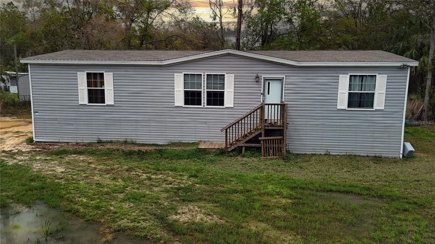 Welcome to a beautifully crafted residence, built in 2022, where modern design meets comfort and convenience. This manufactured home, nestled on a generous lot size of .43 acres, also includes 7711 W Radiance Ln (.46 acres) for a total of .89 acres. This property showcases a blend of vinyl siding and wood frame construction, topped with a durable shingle roof, ensuring both aesthetics and resilience. Step inside to discover a spacious interior of 1,848 square feet, thoughtfully laid out to maximize both form and function. The heart of this home is undoubtedly its kitchen, equipped with essential appliances including a dishwasher, range, and refrigerator, all designed to cater to your culinary adventures. The luxury vinyl flooring throughout the house not only adds an element of elegance but also ensures ease of maintenance. The living spaces are designed with your comfort in mind, featuring central air conditioning and central heating, keeping the ambiance perfect regardless of the season. The family room is the perfect focal point for all gatherings without the worry of upkeep. Boasting three cozy bedrooms, each space is crafted to provide a serene retreat from the day's hustle. All closets are very spacious, presenting a unique opportunity to customize storage solutions to your taste. The two bathrooms complement the bedrooms, ensuring convenience and privacy for residents and guests alike. Outdoor living is equally inviting, with plenty of room for a pool and a garden. The entire perimeter of the property is surrounded by trees, while the entire interior of the property is completely cleared, making it the perfect oasis with plenty of privacy. There are multiple entrances to the property with access from W Ox Eye Pl & from W Radiance Ln with paved road access on both sides enhancing the property's approachability. Utility-wise, the home is well-equipped with modern amenities including BB/HS Internet availability, cable, electricity, street lights, and underground utilities, ensuring a seamless and comfortable lifestyle. The inclusion of a well and septic tank for water and sewer needs, respectively, add an element of self-sufficiency to the property. This residence, devoid of a homeowners association, offers freedom from monthly fees and the flexibility to personalize your living experience without the constraints often found in managed communities. Its location, while not specified, promises a blend of privacy and accessibility, making it a perfect haven for those seeking a balance between tranquil living and convenience. Embrace the opportunity to make this house your home, where every detail is designed with your comfort and lifestyle in mind. Welcome to a space where every day promises the comfort of modern living, nestled within a serene and inviting environment.