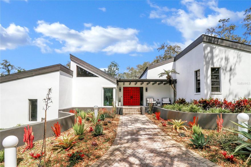 Nestled within the coveted Oak Hill Acres of Tarpon Springs in East Lake, this exceptional estate offers the perfect blend of luxury, modern sophistication, and equestrian charm, spanning over 4,000 square feet of impeccably designed living space. Set on 3.47 expansive high and dry acres, this home is a sanctuary where privacy and elegance meet. No flood insurance is required!

From the moment you enter, the bright and airy design envelops you, showcasing 5 generously sized bedrooms, 2.5 beautifully appointed bathrooms, and an array of thoughtful spaces. Every detail has been meticulously crafted, with cutting-edge smart home integration allowing you to control everything from lighting to climate at the touch of a button. With Wi-Fi-enabled recessed lighting, smart switches, and a Nest thermostat, this home embraces both luxury and modern convenience. 

The heart of the home is the stunning modern kitchen, featuring striking Level 2 Calcutta Quartz countertops, a top-tier ZLine microwave and cooktop, and sleek stainless LG appliances, all updated in recent years to offer modern functionality in a timeless design. For those who love to entertain, a second kitchen and bar, just a year old, adds an extra layer of convenience and style.

The open-concept living room creates a welcoming atmosphere, with a cozy wood-burning fireplace and a large sliding door that bathes the space in natural light. Flow seamlessly from the indoors to the spectacular outdoor living area, where the newly refinished saltwater pool, finished in Caribbean Blue, becomes a focal point. Enjoy the year-round comfort of your pool with its newly added heater (2024), refinished decking (2023), Dr Wellness 6-person hot tub with built-in speakers (2023), and smart lighting around the pool and patio, perfect for evening relaxation or vibrant entertaining.  

The estate also boasts a three-stall horse barn, tack room, and a corral, all set against lush landscaping. The twelve zone Rainbird sprinkler system runs on two wells on the property.  Whether you’re an equestrian enthusiast or simply enjoy the serenity of open space, this property offers endless possibilities. The barn's new electrical panel (2020) adds a touch of modernity to your equestrian needs.

This mid-century modern home is as refined as it is functional, with a new shingle roof (2022), freshly painted exterior (2024), brand new 400 sq ft septic drainfield (2025), and new carpeting in the bedrooms (2023), ensuring comfort and lasting appeal. Some of the windows are hurricane-rated and double-paned, and fill the home with natural light. Two meticulously maintained HVAC systems (3-ton and 5-ton) promise optimal comfort year-round, while a hot water heater (2021) ensures reliability.

For those with an eye for potential, the property offers the perfect space to add an ADU or mother-in-law suite, providing flexibility to accommodate family or guests.

With its exceptional design and breathtaking outdoor spaces, this property invites you to experience seclusion and convenience. Ideally located just 30 minutes from Tampa International Airport and only 15 minutes from the breathtaking beaches and the renowned Tarpon Springs Sponge Docks. If you love outdoor adventures and recreation, you’ll appreciate being near the Upper Pinellas Trail, Brooker Creek Preserve, Lake Tarpon, East Lake Sports Complex, the John Geigle YMCA, and several local golf courses. This is more than a home; it’s a lifestyle.