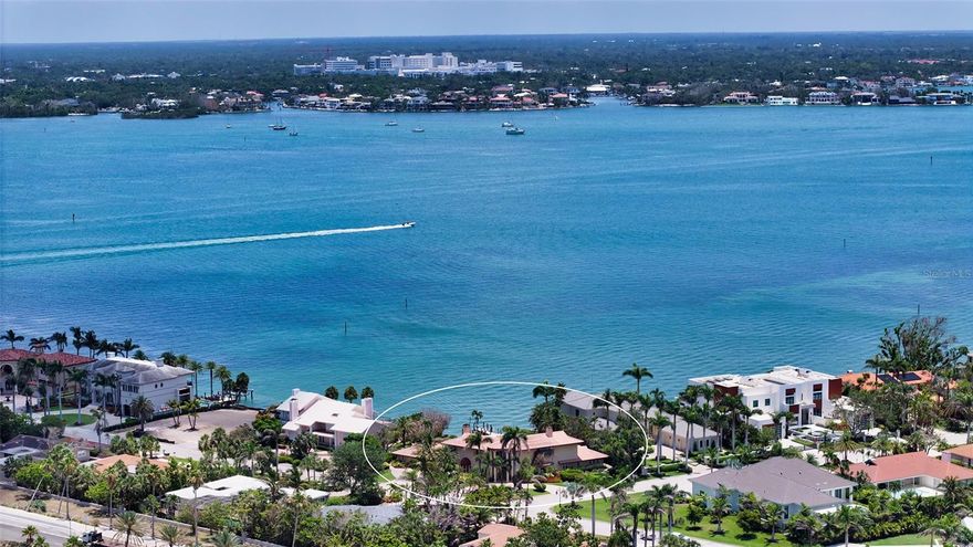 Situated on the exclusive island of Bird Key, expansive corner lot property offers one of the sought after locations in Sarasota. Enjoy sweeping views of Sarasota Bay and downtown, surrounded by mature landscaping that adds privacy and a lush, resort like atmosphere. This spacious home is built for comfort and entertaining, featuring oversized rooms and a layout that flows effortlessly. The large family room and all main living areas open directly to a private backyard that feels like your own resort retreat. Inside, you'll find three bedrooms plus a generous office, ideal for remote work or creative pursuits. A dramatic staircase leads upstairs to the primary suite and another large bedroom both with very spacious closets for ample storage. The property also features a separate guest house perfect for visitors, extended family, or a private studio. With its unbeatable location, panoramic views, and flexible living space, this home is full of potential and ready to be customized to your lifestyle.  The Bird Key location is convenient and has easy access to so many shops and galleries. Beach access for the beachgoers is enjoyable on Lido Key, which offers beautiful beaches and recreational activities, St.Armands for upscale shopping and dining, Also, the Longboat Key Club is a very short distance away, which offers golf and tennis plus several restaurants. Waterfront living is at its best living in Bird Key, which also has a marina and clubhouse. Come enjoy!