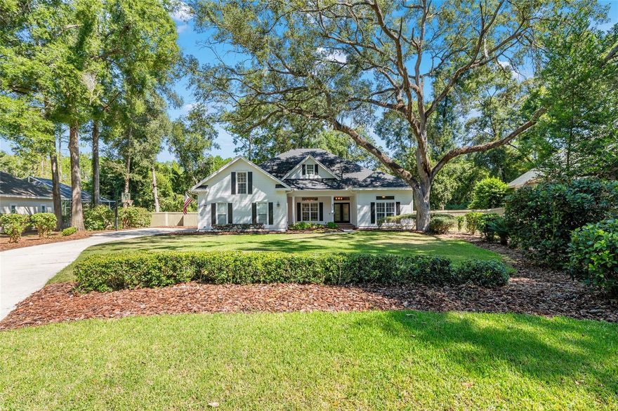 Welcome to this beautifully maintained home located in the sought-after Mills Glen neighborhood of Haile Plantation. Built by renowned builder Paul McArthur, this thoughtfully designed 3-way split floor plan offers approximately 3,010 square feet of living space, featuring 5 bedrooms and 4 full bathrooms. Step inside to an inviting open layout that includes a spacious living room, formal dining room, and a well-appointed kitchen with granite countertops, ample cabinetry, and a sunny eat-in breakfast area. The great room impresses with abundant natural light, French doors, wood flooring, custom built-ins, a cozy fireplace, high ceilings, and elegant crown molding along with other incredible millwork. The intelligently designed layout includes two bedrooms sharing a full bath, along with a private guest suite featuring its own en-suite bathroom ideal for visitors or extended family with the fifth en-suite versatile bedroom tucked away upstairs making it a great bonus room or home office. The expansive primary suite is a true retreat, complete with tray ceilings, a sitting area, large windows, a generous walk-in closet, and a luxurious bathroom offering a jetted tub, walk-in shower, dual vanities, and direct access to a private screened porch. Additional features include a well-equipped laundry room with extra storage and a utility sink, plus a two-car garage with a large storage closet. Enjoy outdoor living on the spacious screened lanai overlooking a secluded, fenced backyard including a gorgeous, newly installed paver patio area backing up to a private common area. Residents love the walkable lifestyle with easy access to Haile Village Center’s restaurants, shops, and the popular Saturday farmers market. Haile Plantation is a vibrant golf course community offering parks, playgrounds, pools, tennis courts, paddle ball courts, and miles of walking trails. Conveniently located near Celebration Pointe, UF/Shands, VA, top-rated schools, dining, and more.