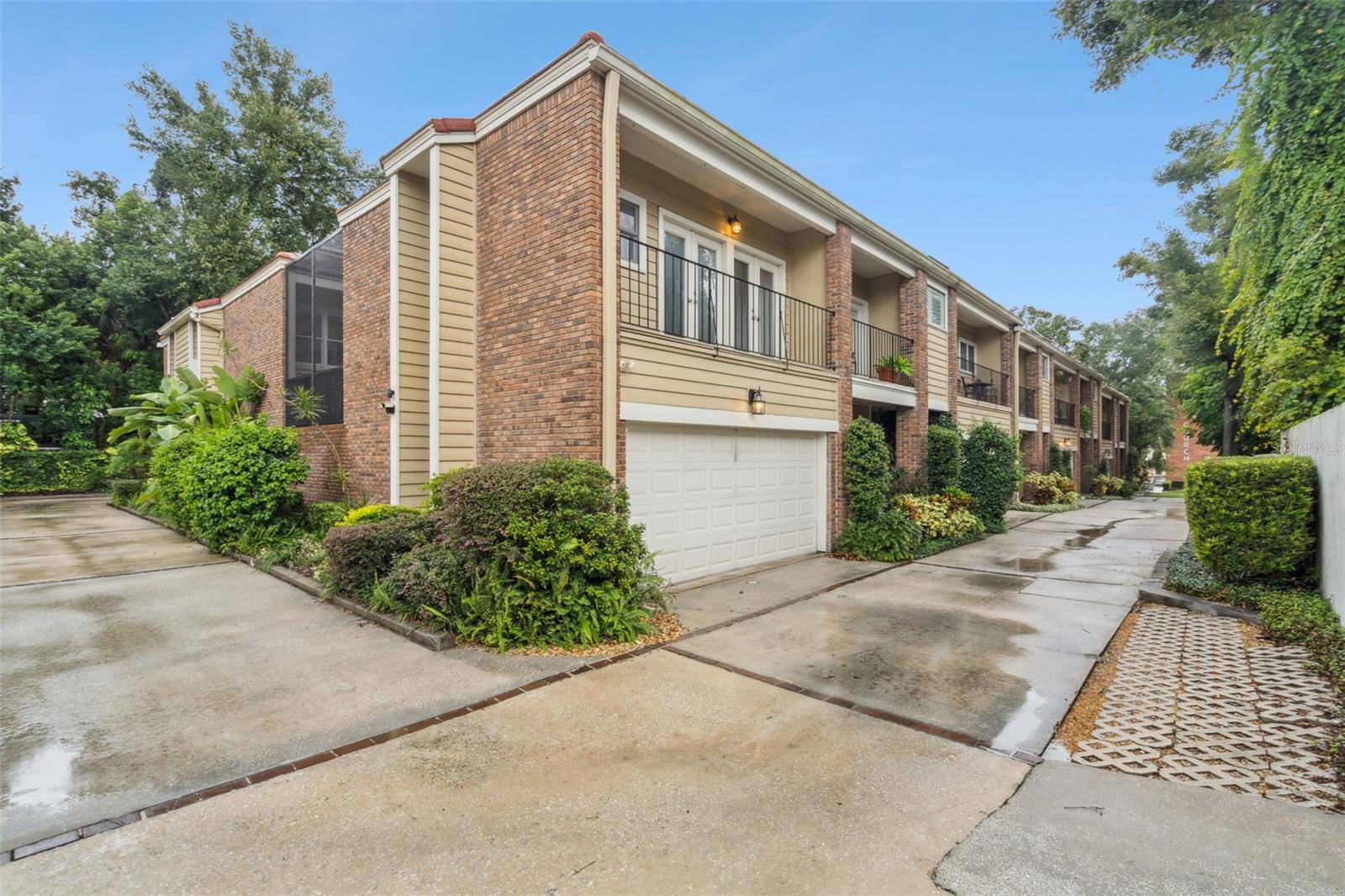 Embrace urban living with this unique 3-bedroom, 3.5-bath townhome-style condo in the heart of Downtown Orlando’s Mills 50 District—steps from Lake Eola, Thornton Park, Mills Market, and the city’s best dining and nightlife. The open layout welcomes you with spacious living and dining areas, a stylish kitchen with granite counters, stainless steel appliances, bar-top seating, and a secondary living space with a wood-burning fireplace. Upstairs, two oversized bedrooms feature en-suite baths and walk-in closets. A private garage apartment with its own entrance sits above the two-car garage—perfect for guests, in-laws, or rental income. Between the main home and garage apartment, a screened courtyard offers a private retreat for relaxing or entertaining. Turn-key upgrades include hardwood floors, large windows for natural light, and french doors to the courtyard. Recent updates: HVAC (2022), roof resealed (2024), Hardie board siding, and composite deck.