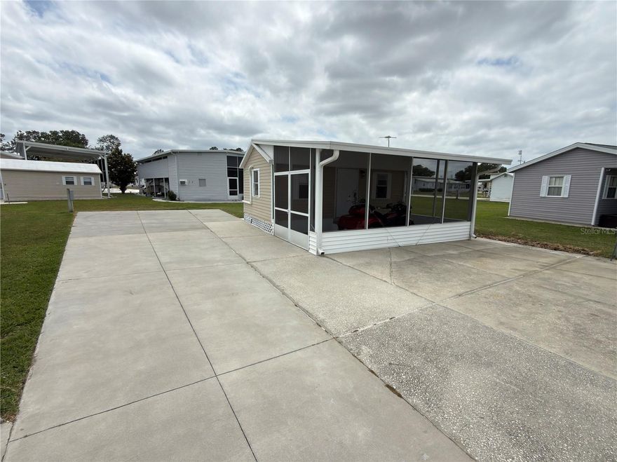 Few opportunities like this surface in one of Central Florida's most established Class A motorhome communities. This generously sized concrete pad is engineered to handle any Class A motorhome, with room to simultaneously host up to two additional guest rigs — all serviced by 200-amp electrical and full RV utility hookups on both sides of the pad.
The climate-controlled casita shed goes well beyond storage. Thoughtfully outfitted for day-to-day living, it includes a comfortable sitting area, mini refrigerator, television, ceiling fan, and a dedicated computer workspace. The full bathroom is equally well-appointed, with a washer and dryer, shower, toilet, sink, water heater, and exhaust fan. Step outside and the attached screened-in covered porch extends your living space even further — a natural spot for morning coffee, evening conversations, or simply enjoying the Florida air without the bugs. Whether you need a guest suite, a quiet home office, a hobby space, or simply a place to decompress — this casita delivers.
The lot's oversized footprint leaves meaningful space for future improvements, including the addition of a manufactured home or an RV port — giving you the flexibility to evolve the property as your lifestyle and priorities shift over time. The annual HOA fee covers basic lawn care and common area upkeep, so the community stays sharp year-round without the burden falling entirely on individual owners.
Sitting just 3.5 miles from I-4, Mount Olive Shores punches well above its weight on convenience. Tampa International, Orlando International, world-class medical centers, major retail corridors, and Central Florida's top attractions are all within roughly an hour's drive.
The newly built 5,000-square-foot Community Center raises the bar for what RV community living can look like — featuring a full commercial kitchen, regulation pool and shuffleboard tables, dart boards, arcade games, a card room, library, vending area, and a covered BBQ lanai. A packed social calendar — bingo nights, karaoke, potluck dinners, holiday events, and more — means the community is genuinely alive, not just well-manicured.
Mount Olive Shores is a deed-restricted community. Ownership or lease of a Class A motorhome is required during your first year of residency — a standard that protects the character and long-term value of the neighborhood. This is premium RV real estate in a community that has stood the test of time. Opportunities at this level don't wait.