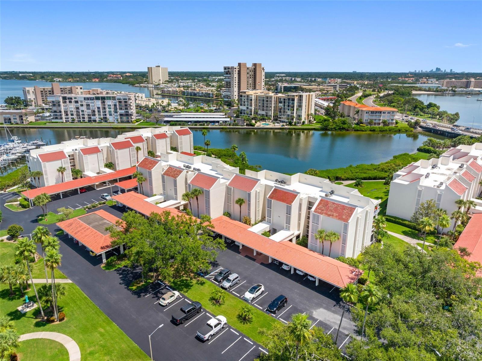 This is your opportunity to own a piece of paradise at Harbourside in South Pasadena! This highly desirable, all-ages, pet-friendly community offers 24/7 guard-gated security, resort-style amenities, lush tropical landscaping,direct waterfront access and only 2 minutes to the beach. Step inside this beautifully updated 1-bedroom, 1-bath condo, where abundant natural light fills the expansive 28' x 14' living and dining area. Sleek luxury vinyl flooring enhances the sense of openness and style, while a wall of glass sliders frames panoramic views of Boca Ciega Bay and the community’s meticulously maintained grounds. The inviting Florida Room, with its floor-to-ceiling sliders, provides the perfect spot to relax and take in the stunning water and garden views. Best of all, set at an elevation of 12 feet above sea level, this condo offers an extra measure of security and comfort. That accounts for the fact that it was completely unaffected by the 2024 hurricanes—no water intrusion at all. This is not your ordinary 1st floor condo #103 sits 12 feet above sea level. At 14 x12, this spacious room provides exceptional versatility — perfect as a guest room, office/TV room, or, with sliders open, a breezy balcony for entertaining. The spacious 16x14 bedroom includes a generous walk-in closet with sliders to the Florida Room. The open floor plan seamlessly connects the living, dining, and kitchen areas. The kitchen blends natural wood cabinetry with neutral quartz counters and stainless steel appliances, while the updated bath features newer cabinetry, a quartz countertop, and a tub/shower. This condo is sold FURNISHED with high end pieces from Matter Bros. New HVAC in 2024 and new water heater in 2019. For added convenience, the condo includes an inside laundry with washer and dryer, plus a covered, assigned carport (#203). Square footage does not include Florida Room. Harbourside is a private, guard-gated island community offering a wealth of amenities: beautifully landscaped grounds, a marina with 87 deeded slips, kayak storage, 5 tennis courts with pickleball, 6 swimming pools, shuffleboard, saunas, a hot tub, a 1.5-mile waterside walking path, fitness centers, a country club–style clubhouse with an active social calendar, woodworking and ceramics studios, car wash stations with vacuum and air, EV charging stations, and more. All this just 1.5 miles from St. Pete Beach and Corey Avenue’s shops, dining, and services. With on-site maintenance and management, Harbourside is always pristine and secure. Beauty, comfort, activity, and peace of mind — Harbourside has it all. Experience the best in waterfront living. View the Virtual Tour, then schedule your private showing of this Harbourside gem today!