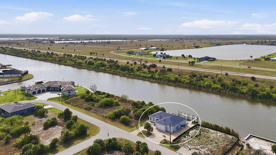 Experience elevated waterfront living in this beautifully designed 2020-built coastal home located in the highly sought-after boating community of South Gulf Cove. Perfectly positioned on sailboat water with no bridges to the Gulf, this property offers direct access to open water and features a private dock capable of accommodating a sailboat or larger vessel — a true boater’s dream.

With 3 bedrooms and 3 bathrooms, this home blends modern coastal style with functionality. The open-concept floor plan is filled with natural light and features expansive living spaces designed for both everyday comfort and effortless entertaining.

The kitchen serves as the heart of the home, offering abundant cabinetry, quality appliances, and generous counter space that flows seamlessly into the dining and living areas.

Step outside to one of the home’s standout features — a large covered lanai with desirable southern exposure, ideal for relaxing, outdoor dining, and entertaining year-round while enjoying wide canal views, peaceful surroundings, and the Florida breeze.

Designed with boating and adventure in mind, the property includes a dedicated parking pad next to the home, perfect for RV owners, boat trailers, or additional vehicles, along with a spacious 3-car garage providing ample storage for all your toys and gear. The garage is further enhanced with convenient double side access doors and a 400-amp electrical service, offering exceptional functionality and capacity for recreational equipment, workshop use, or future expansion.

For the ultimate coastal lifestyle experience, an elevated observation deck offers stunning vantage points to take in sunsets, watch passing boats, or simply enjoy the tranquility of waterfront living enhanced by the home’s prime southern-facing orientation.

Located just a short drive from the world-class beaches of Boca Grande and Manasota Key, this home provides easy access to fishing, boating, dining, and the very best of Southwest Florida’s outdoor lifestyle.

Whether you're searching for a primary residence, seasonal retreat, or investment opportunity, this waterfront property offers the rare combination of modern construction, boating access, wide water views, and exceptional outdoor living, with thoughtful upgrades already in place to support an active coastal lifestyle.