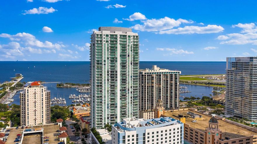 Experience elevated downtown living at ONE St. Petersburg. This stunning 2-bedroom plus den, 2.5-bath residence offers 1,522 sq. ft. of refined interior space and unobstructed WATER VIEWS overlooking the downtown waterfront and iconic St. Pete Pier.
Step inside to an open, modern floor plan featuring sleek porcelain tile throughout the main living areas and a chic neutral-toned stone accent wall that creates a warm yet sophisticated ambiance. The gourmet kitchen is outfitted with stainless steel appliances, filtered water dispenser at sink, ample storage, and designer lighting. A private balcony extends your living space outdoors; perfect for morning sunrises, alfresco dining, or simply enjoying the glimmer of Tampa Bay.
Both bedrooms provide serene bathrooms, while the primary suite is enhanced by a generous walk-in closet. The additional den offers adaptable space perfect for a stylish home office, media lounge, or guest retreat.
Residents of ONE enjoy world-class amenities, including a dramatic 40,000+ sq. ft. elevated amenity deck with a resort-style pool, private cabanas, outdoor kitchen and lounge areas, a state-of-the-art fitness center, and both formal and informal club rooms. Additional conveniences include a 24/7 staffed front desk and secure building access.
This residence also conveys two premium parking spaces and a climate-controlled storage unit, enhancing comfort and convenience.
Perfectly situated in the heart of downtown St. Petersburg, you're just steps from waterfront parks, the St. Pete Pier, acclaimed museums, fine dining, boutique shopping, marinas, and vibrant year-round events. Live the luxury lifestyle that only ONE St. Petersburg can offer.