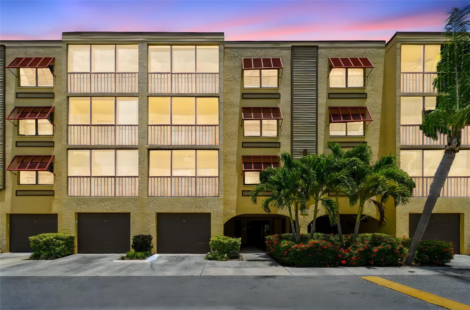 Florida living at it's finest. Come see this beautifully updated meticulously maintained condo at 6000 Park Place that offers a truly exceptional living experience. This 2-bedroom, 2-bath residence boasts contemporary enhancements, a desirable split floor plan, and serene water views from both the front and back, providing a tranquil atmosphere throughout. I believe the view from this particular unit is the best within the entire property. The recently updated eat-in kitchen is a highlight, featuring newer appliances, an abundance of real wood soft-close cabinets with undermount lighting, a modern farm sink, quartz countertops, a stylish glass backsplash, and recessed LED lighting, all complemented by charming plantation shutters. Flowing seamlessly from the kitchen is a spacious dining and living room combination, where you can enjoy breathtaking water views of the lake below. Additionally, the versatile screened-in sunroom offers a perfect space for relaxation. The primary bedroom is generously sized, easily accommodating a king-size bed and includes a private balcony access. It features an en suite bathroom equipped with dual sinks, modern floor tiles, a luxurious custom Jacuzzi shower, and a huge walk-in closet. For added convenience, the condo includes an inside laundry room, a new water heater, and a deeded oversized 1-car garage with a new garage door opener. The vibrant community at 6000 Park Place offers outstanding amenities, such as a heated swimming pool, hot tub, tennis court, pickleball, and shuffleboard courts. The clubhouse provides a sauna, exercise room, TV, billiards table, and a fully equipped kitchen available for rent for special events. The location is truly unbeatable, with The Publix Shopping Center, major retail shopping, and a variety of restaurants just next door. Furthermore, you're only a short 10-minute drive to the Gulf beaches and 25 minutes from Downtown St. Petersburg. The HOA fee is comprehensive, covering cable, water/sewer, trash removal, exterior maintenance, and the use of all community amenities. This elegantly upgraded condo in such a fantastic location is a wonderful opportunity that shouldn't be missed.