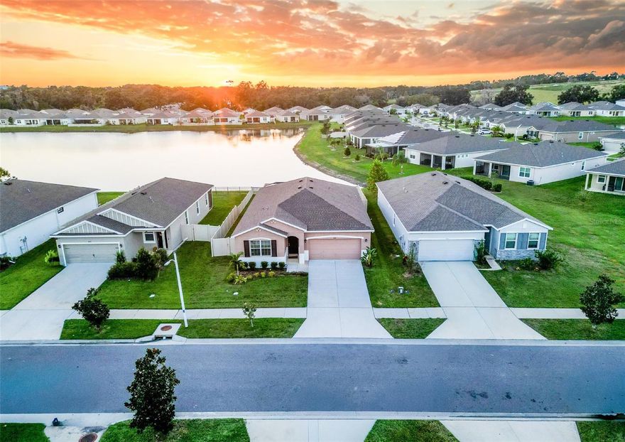 One or more photo(s) has been virtually staged. Where Every Evening Ends in a Gorgeous Sunset. 
This home is a front row seat to a daily florida sunset. Perfectly positioned on a rare west facing pond lot in Abbott Park, Zephyrhills, this three bedroom, two bath home captures the best of Florida’s natural beauty,  from peaceful morning sunrises out front to breathtaking golden hour sunsets reflecting across the pond each evening.
Built in 2022 and still feeling essentially brand new, this home offers peace of mind with no worries about upkeep or maintenance for years to come. It has been cared for with genuine pride, a reflection of owners who truly loved where they lived.
The thoughtful single story split floor plan places two bedrooms toward the front of the home, while the primary suite enjoys quiet privacy in the rear, with views of the pond. A dedicated laundry room sits conveniently near the primary suite, keeping chores separate and the garage open for full use or storage flexibility.
Relax under the screened in lanai, soak in the heated above ground spa, and take in open water views framed by white vinyl fencing that preserves both privacy and perspective. Every detail, from the landscaping to the natural light that fills each room, tells the story of a home ready for someone new to call it their own.
A rare opportunity to own one of Abbott Park’s most picturesque lots, where tranquility, comfort, and pride of ownership come together beneath a sunset sky that never fails to impress.  Book your showing today!