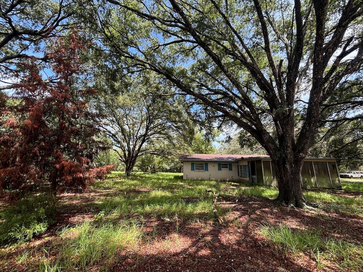 Auction Property. LIST PRICE IS FOR MLS PURPOSES ONLY. ACTUAL PRICE WILL BE DETERMINED AT AUCTION. ONLINE AUCTION ENDS AUG. 19 AT 1 PM ET. Tucked away down a private road in Fort McCoy, FL, this unique property offers the kind of seclusion, freedom, and self-sufficient lifestyle that’s hard to come by. If you’re someone who values privacy, wide-open acreage, and the chance to live off the land, this place just might speak your language. This is a 10± acre parcel with a modest home, a Generac whole-house generator, a barn full of history (and a few decades of accumulated treasures), and partial fencing. This 2 bedroom, 2 bathroom block home is a classic “clean it up or keep it quirky” kind of place—perfect for those who see charm in character and opportunity. The property is being sold with all contents. The 10± acre parcel also includes a small pond that straddles the northern property line, with approximately half located on this parcel and half on the neighboring parcel to the north. There is a dock that needs major work. The land is a mix of hardwoods and moist low areas, great for exploring or watching wildlife. On the south & east side of this 10± acre tract, you’ll find two additional parcels up for auction; abutting the east end of the property, a 12.85± acre wooded tract, and abutting the southeast side of the property, a 6.24± acre parcel that could adjoin either. These will all be offered separately at auction. Buy one, two, or all three—providing up to approximately 29± acres. Whether you're expanding your footprint, creating a multigenerational homestead, farming, or inviting your neighbors to join in, there's room here to spread out. Located in Fort McCoy, FL, just 18± miles northeast of Ocala, this rural community sits near the Ocklawaha River and Ocala National Forest, offering easy access to trails, hunting, fishing, and all kinds of outdoor adventure. This sale is subject to court approval. Property #: DG1492. Bid Online August 12 - 19. 10% Buyer's Premium.