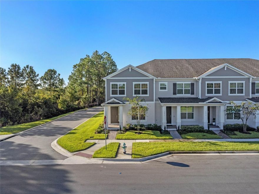 Location at its finest! This exceptional corner-unit townhome offers serene WATER VIEWS and borders a private PRESERVE, providing rare privacy and natural beauty.

Thoughtfully designed, this 4-bedroom, 3 full-bath residence also features a spacious loft, wood-look TILE flooring, upgraded lighting, and an extended fenced patio (approximately 13x25) — perfect for outdoor entertaining. The 2-car garage is enhanced with durable EPOXY flooring.

Upon entry, a welcoming wide hallway leads into the bright and open living space. A generously sized bedroom and full bath are conveniently located on the first floor, ideal for guests or a private home office, complete with tranquil pond and preserve views.

The kitchen is beautifully appointed with QUARTZ countertops, stainless steel appliances, a pantry, and ample seating space for bar stools and a dining table beneath a stylish light fixture. Natural light pours in throughout the home, creating an airy and inviting atmosphere. Enjoy preserve views from nearly every window.

Step through the elegant FRENCH DOORS to the extended patio and enjoy grilling, relaxing, and entertaining in your private outdoor retreat. Upstairs, you’ll find the spacious primary suite, two additional bedrooms, a versatile loft, and a conveniently located laundry room.

The primary suite features a walk-in closet, dual sinks with QUARTZ counters, and a tiled shower with a built-in bench and window for added natural light.

Exterior upgrades include paver walkways, driveway, and patio. Community amenities include a resort-style zero-entry POOL, splash pad, cabana, dog park, and playground.

Ideally located near Hamlin’s shopping and dining district, with convenient access to restaurants, grocery stores, a movie theater, medical facilities, golf courses, major highways, and theme parks.

End units with water views and added privacy are a rare opportunity in Winter Garden.