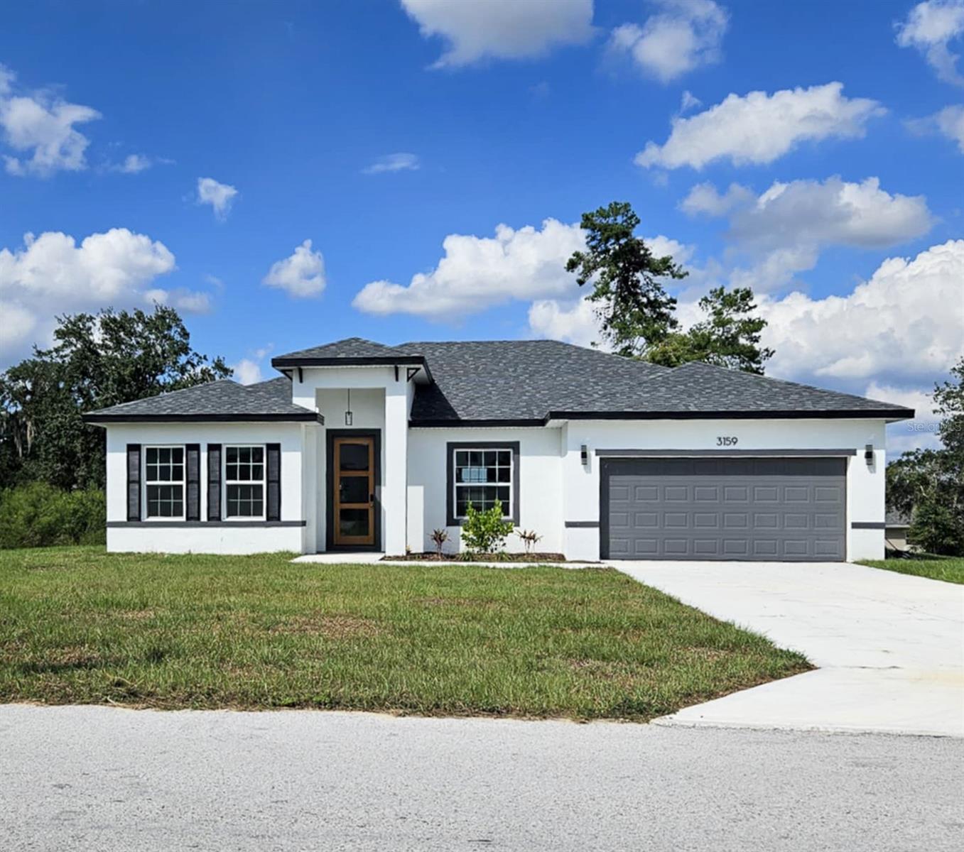 Welcome to your dream home in Ocala, FL! This new construction home boasts four spacious bedrooms and two full bathrooms, perfect for those who value comfort and style. The open floor plan is accentuated by high ceilings, creating a sense of space and freedom. The kitchen is a chef's dream, equipped with stainless steel appliances, including a microwave, dishwasher, refrigerator, and oven/stove. The island/breakfast bar with stone countertops is perfect for casual dining or entertaining. Luxury vinyl wood plank flooring throughout the home ensures easy maintenance and a modern aesthetic. The master suite features a walk-in closet and a walk-in shower, adding a touch of luxury to your daily routine. The split-floorplan design offers privacy and convenience. A two-car garage provides ample storage and parking space. This pet-friendly home welcomes both you and your furry friends. The property is conveniently located near Marion Oaks Elementary School, Bellview Middle School, and Forest High School, making it an ideal location for educational accessibility. Experience the perfect blend of luxury and convenience in this stunning Ocala home. $250 Non-Refundable Pet Deposit.