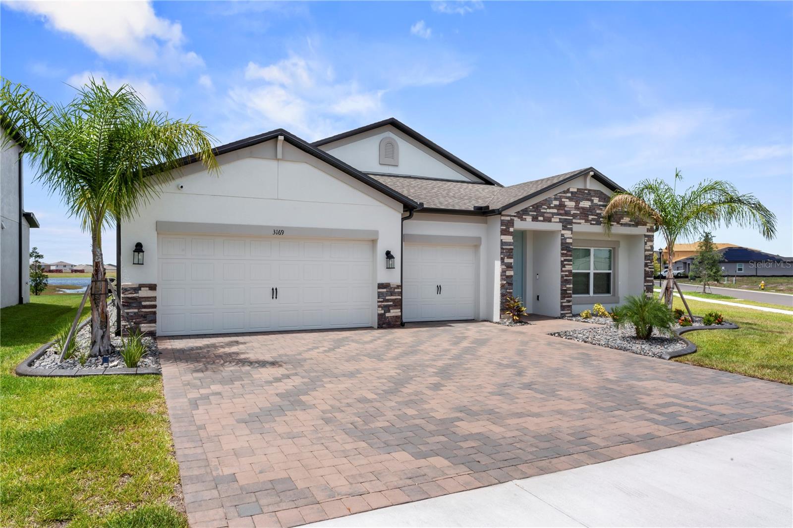 Welcome home to this beautiful fully upgraded and brand new built Barcella home in the desirable community of Berry Bay. This 4 bedroom 3 bathroom and 3 car garage home has an open floor plan and is perfect for the growing family. As soon as you pull into the freshly sealed paver driveway you will be greeted by gorgeous landscaping and Royal palm trees. The home features very tasteful upgrades throughout, including wood tile flooring, decorative ceiling fans, upgraded door hardware, baseboards, and modern light fixtures. The open concept design includes a gourmet kitchen with built in cafe/eat-in and dinning room. The kitchen features granite countertops, 42" cabinets with hardware and crown molding, built in oven, and stainless appliances. The covered and screened in back patio is accessed by the the upgraded 3 sliding glass doors that brings the outdoor space in. Relax at the end of the day on your back patio with wonderful views of the pond and conservation area. The master bedroom has lots of natural light, a tray ceiling, and a huge walk-in-closet that accommodates both his and her clothing. The master bathroom is spacious and includes an oversize shower with separate tub. The three additional bedrooms are a nice size with ample closet space. Other upgrades include a surveillance system with smart home doorbells and locks, ceiling speakers and pre-wired surround sound system. Berry Bay is a great community with a low, $100 a year HOA fee, resort style swimming pool and clubhouse, playgrounds, and pickle and basket ball courts. With easy access to I-75, Tampa, St. Pete and the gulf beaches are only a short 30 to 45 minute drive. This home is a must see to appreciate all the upgrades and features! Call today to schedule your private showing.