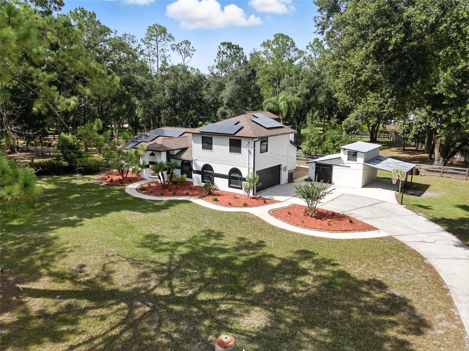 Have you been dreaming of slowing life down just a bit? Making time for the things that bring you joy? Of trading traffic noise for birdsong and city lights for starlit skies? Imagine: sipping your morning coffee while baby goats and chickens roam on your massive 1.5+ acre fully fenced property in the sleepy, tucked-away community of Quail Hollow. So close, yet so far from it all!
This beautifully appointed 4-bedroom, 2.5-bath estate offers the perfect blend of charm, comfort, and modern convenience. With whole-house hurricane impact windows and solar panels, you’ll enjoy year-round energy efficiency and peace of mind.
Step inside to tall ceilings, an open-concept layout, updates you'll love and still room to add your own touches. Imagine the smell of fresh bread coming out of the oven in your tastefully updated kitchen that flows effortlessly into the spacious living area, ideal for both cozy family nights with the wood burning fireplace and ample space for entertaining. The new flooring adds a fresh, modern touch, while the split floor plan ensures privacy and flexibility. The primary suite, home office, and two baths are thoughtfully situated on the main level, while upstairs you'll find two additional bedrooms, a full bath, and a generous loft for added flexibility—perfect for guests, office, playroom, or creative space.
The REAL showstopper of this estate? The resort-style pool with sparkling waters, hot tub, new pool deck, and an oversized screened enclosure with a covered patio—creating the ultimate and seamless indoor-outdoor living experience. This property screams "everyone's favorite house to hang out at".
For the hobbyist, tinkerer, or collector, the A/C’d workshop, 2-car garage, and additional carport offer room for all your tools, toys, and treasures. Yes, you can bring the boat, RV, ATV, jet skis and still have room to spare!
Whether you’re an animal lover, hobby enthusiast or simply craving a more peaceful way of life, this property offers space to breathe and grow—without sacrificing proximity to shopping, restaurants, and city conveniences.
Your peaceful retreat is waiting, schedule your tour with us today!