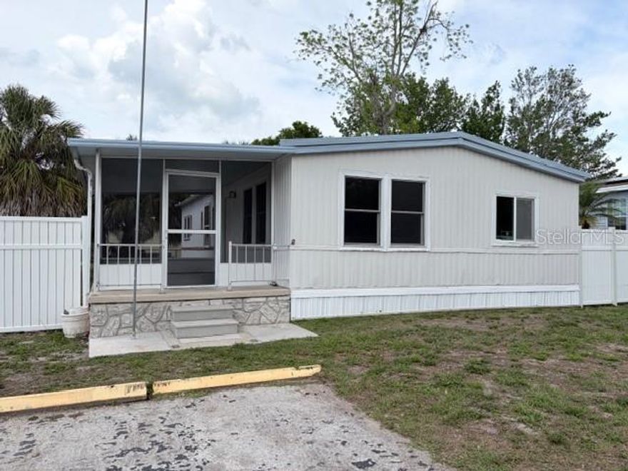 Homeownership awaits!! This fantastic manufactured home with many updates and upgrades is affordable and ready for you! Bring your finishing touches to the remodeled home! From the subfloor to the dryway to the flooring the updates through the years are numerous! Updates include: the stunning white kitchen cabinets, gorgeous granite countertops, appliances, baths, windows, water heater, HVAC and more! A huge breezy screened lanai! A fenced yard and ample parking! Marble tile in the baths! The primary bedroom boasts an ensuite bath and sliders to the spacious backyard! The HOA fee is just 22 dollars a month and the community has a sparkling pool and clubhouse for events! All ages! Pet friendly! Affordability and convenience! The location is perfect! Close to shopping, schools, parks, restaurants with easy access to Tampa, St Pete and Clearwater beach! Own your own home and spacious lot! The kitchen is a chefs dream with tons of cabinets and counter space and a gorgeous Island with extra seating and entertaining space! Great buy! Great location! Great opportunity!