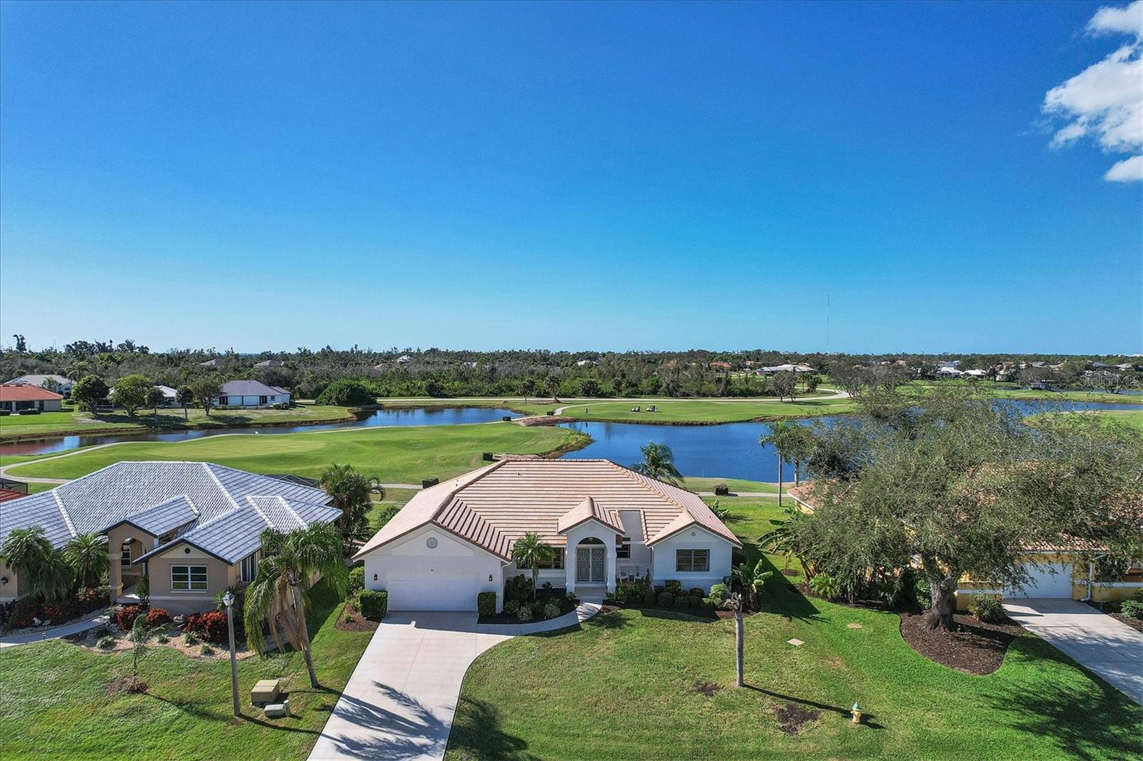Enjoy a breathtaking golf course and water view from the large screened lanai and nearly every room in this immaculate and renovated home in Cape Haze Windward. The prime location on a exquisite street, the property provides vistas of multiple golf course holes and long views of three large lakes. The 3 bed, 2 bath home has a 2023 concrete flat tile roof, an open floor plan, large kitchen, an abundance of natural light, stunning wide luxury vinyl plank flooring, renovated guest bath, and new bedroom carpeting. The property is newly painted inside and out, and has beautiful manicured landscaping. The pristine neighborhood of Cape Haze Windward offers the charming Cape Haze Links golf course, generous Association greenbelt spaces, and canals and large Coral Creek estuary to enjoy. Walk to Association Kayak launch or boat over to private beach Walk, bicycle or golf cart to the Publix shopping center that includes all the essential shops. Just minutes to historic Boca Grande, miles of serene sandy beaches, three full service marinas, world-class fishing and boating, and numerous public and private golf courses.