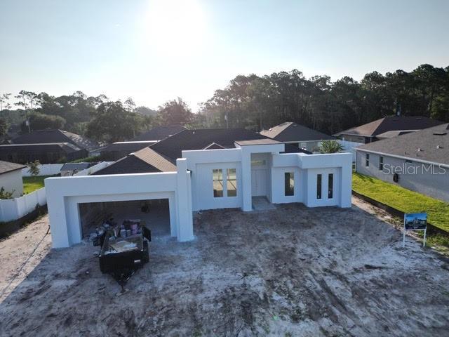 Under Construction. Under construction – this beautifully designed 3-bedroom, 2-bath modern pool home combines striking contemporary style with everyday comfort. A dramatic 16-foot entry opens to an expansive living area with 12-foot ceilings, custom ceiling detail, and oversized energy-efficient windows that fill the home with natural light, while a 16-foot 4-panel sliding glass door blends indoor and outdoor living. The chef’s kitchen features an 11-foot quartz waterfall island with pop-up outlets and wireless charging, premium appliances, built-in oven and microwave, island cooktop, and walk-in pantry. The private primary suite offers direct pool access, a large walk-in closet, dual floating vanities with quartz countertops, an oversized walk-in shower, and a freestanding soaking tub, while the guest bath also opens to the pool for a true resort feel. Additional features include a laundry room with quartz counters and utility sink, an oversized insulated 2-car garage with epoxy flooring, 18-ft glass-paneled door, 8-ft windows, side entry, and EV-ready wiring, with the garage fully prepped for optional A/C. The home also includes energy-efficient systems tucked away in interior closets for added storage, a covered patio with outdoor summer kitchen and screened pool, a concrete turf driveway, exterior block walls, and 8-ft solid-core doors throughout. Ideally located just minutes from Flagler Beach, shopping, dining, parks, and schools, this home offers a perfect balance of luxury, function, and coastal Florida lifestyle. Photos shown are of a model home by the same builder. Property is under construction and viewings are strictly by appointment only—please contact the listing agent. Do not go to the site without an appointment.