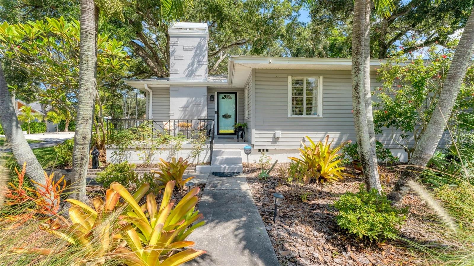 This charming mid-century craftsman style home has been well maintained and is situated on a large corner lot at the edge of the desirable River District. With 4 bedrooms, 2 baths, 1 car garage, this home features hardwood, laminate and tile throughout. Additional flex room behind French doors can be used as a den, office, media or exercise room, to name a few options. The wood burning fireplace is a focal point of the comfortable living/dining room area and is plumbed for gas, if you prefer. Primary bedroom has large bath with dual sinks, spacious closet and access to the garden. Enjoy the beautifully landscaped yard with mature trees and plenty of room for a pool. Metal roof accentuates the architecture of this home. Sellers have done many upgrades including updating cast iron plumbing, replacing kitchen appliances and adding granite. This comfortable home is conveniently located to the downtown Riverwalk to the east and Gulf beaches to the west along with plenty of shopping, dining and entertainment options.