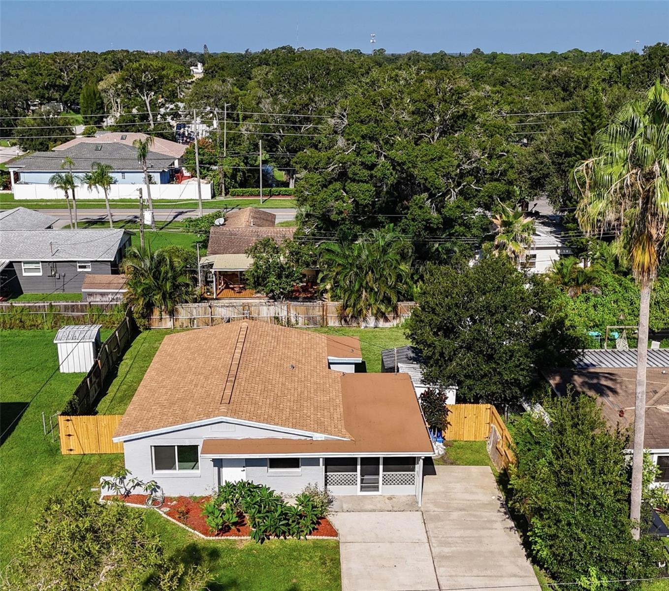 Completely Renovated Block Home – 3BR/2BA. Move-in ready with a NEW ROOF (2025) and an extended driveway for Cars, RVs, Boats, or Golf Carts. No Flood Zone, NO HOA, NO CDD! Bright open layout with luxury vinyl flooring, LED lighting, and New Windows (some are even impacted rated). Stunning kitchen with Quartz countertops, all new cabinets, stainless steel appliances, and a large island. The primary suite features a walk-in shower with glass doors; both baths are fully updated with new vanities and custom tiles. Step outside to enjoy the completely wood-fenced backyard with 2 utility storages, and a versatile enclosed screened patio—perfect for entertaining guests, pets, or simply relaxing year-round.