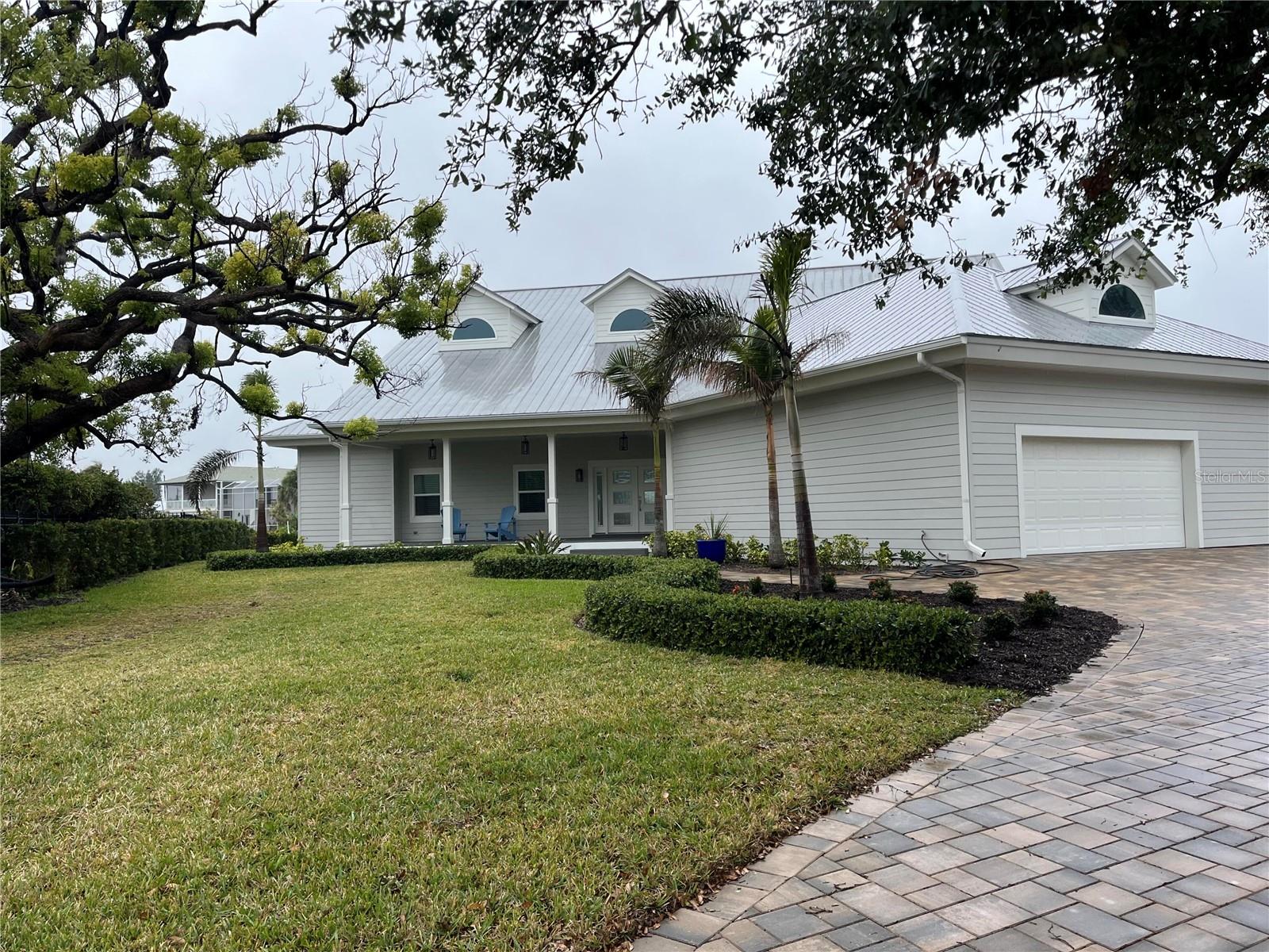 Coastal contemporary waterfront 3 bedroom, 3 bathroom home in desirable NW Bradenton. Close to the beaches of Anna Maria Island but just a few minutes from downtown restaurants and hospitals. The exterior of the home has been recently updated with Hardiplank siding and PGT impact windows and sliding doors. A newer seawall and a 12K lift for year round boating help make this home truly special. The homes on this inlet higher elevations and direct access to the Gulf. Interiorly, the upstairs consists of two wings. On one side, a large master with stunning master bath and walk in closet. One the other, a massive family room. This could easily be converted to another bedroom, bath and office space. Downstairs are 2 large bedrooms with walk in closets, 2 baths, and a large laundry room. An open concept living area showcases the spacious kitchen, dinette, formal dining, and living room with fireplace. All recently upgraded and ready for its new owners! Oh, and one more thing. A rare basement for storage! Presently, a brand new aluminum deck railing is being placed and minor Milton dings are being repaired.
