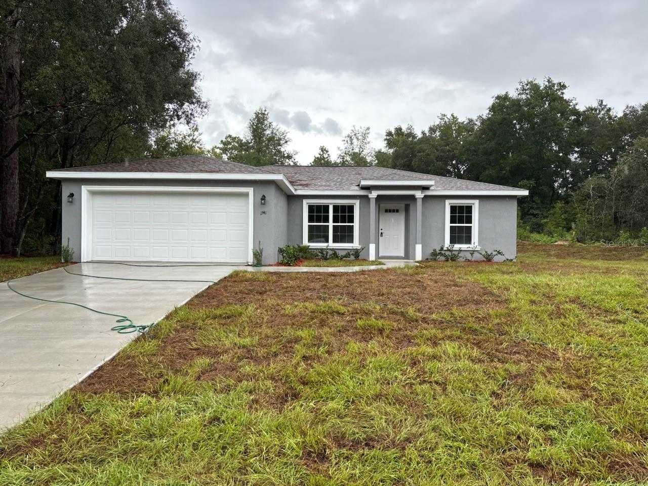NEW CONSTRUCTION. MOVE-IN READY! This Key West Model offers 3 bedrooms, 2 bathrooms, and 1,405 square feet of well-planned living space with the largest master suite this builder provides. Inside, you will find a vaulted ceiling in the living room, stainless steel appliances, custom white shaker cabinets with soft-close drawers, granite countertops in the kitchen and baths, a kitchen pantry, and a subway tile backsplash for a clean, modern look. The master bathroom features a glass-enclosed shower and upgraded marble-look tile, while the guest bathroom includes the same upgraded tile and a convenient tub and shower combination. Luxury vinyl plank flooring runs throughout the home for both style and easy care. Additional comforts include energy-efficient double-pane windows, a laundry room with an upgraded cabinet package, and an attached two-car garage with an opener and remotes. Outdoors, you can enjoy a covered patio and a nice, large backyard that is perfect for relaxing or entertaining. Built with concrete block construction and topped with a 30-year architectural shingle roof, this home also comes with a 10-year structural warranty. Located in flood zone X, the property sits high and dry, eliminating the need for flood insurance. With no HOA fees, you can enjoy true freedom.