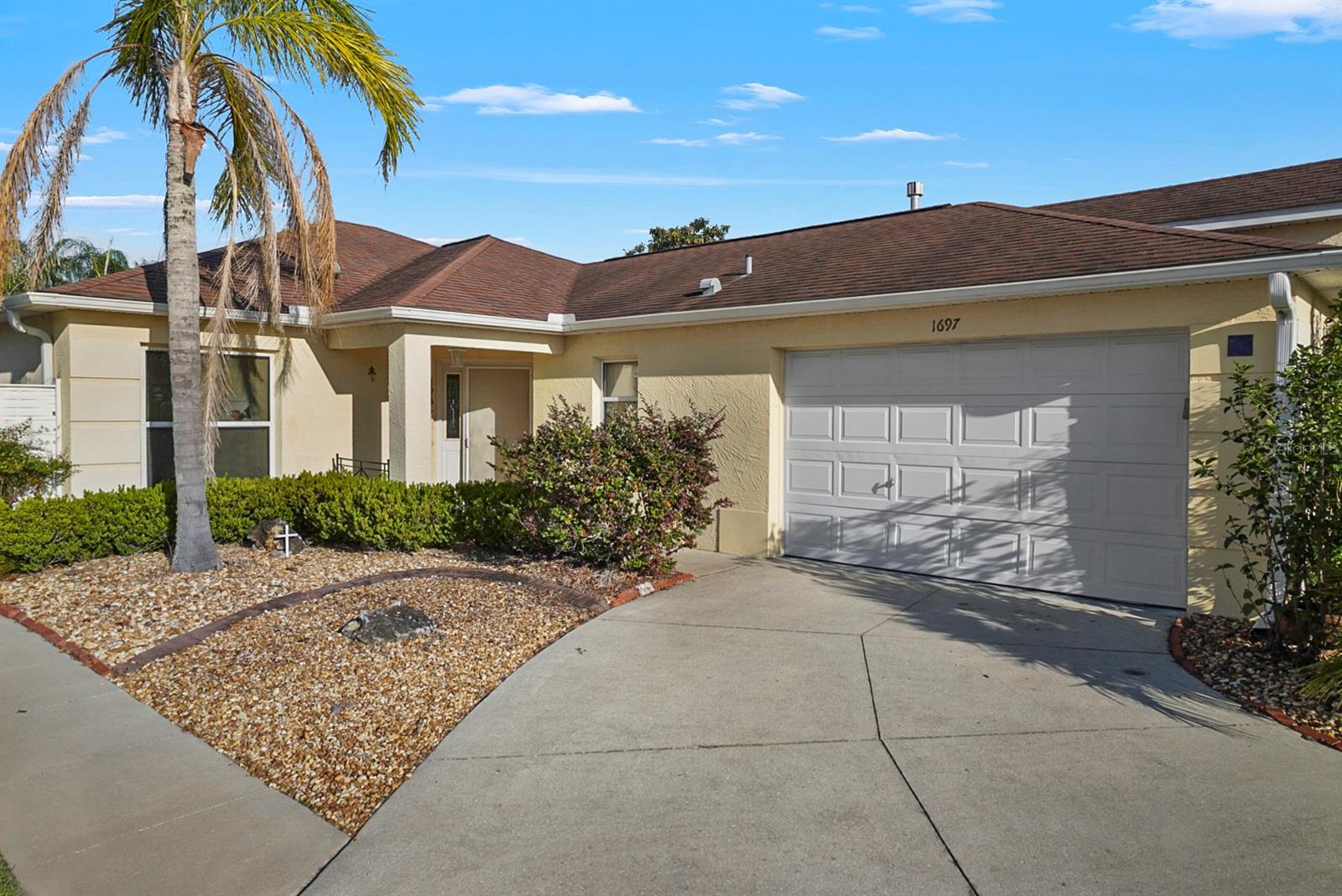This bright, airy home features soaring ceilings, stylish ceramic tile floors, and a stunning saltwater pool in your private backyard oasis. Enjoy peaceful mornings with the sun on your lanai, surrounded by lush landscaping and custom touches like river rock flooring and sliding patio doors. With low utility bills, natural gas, and a newer roof, this move-in ready gem is just 6 minutes by golf cart to Lake Sumter Landing, pools, golf, and more!