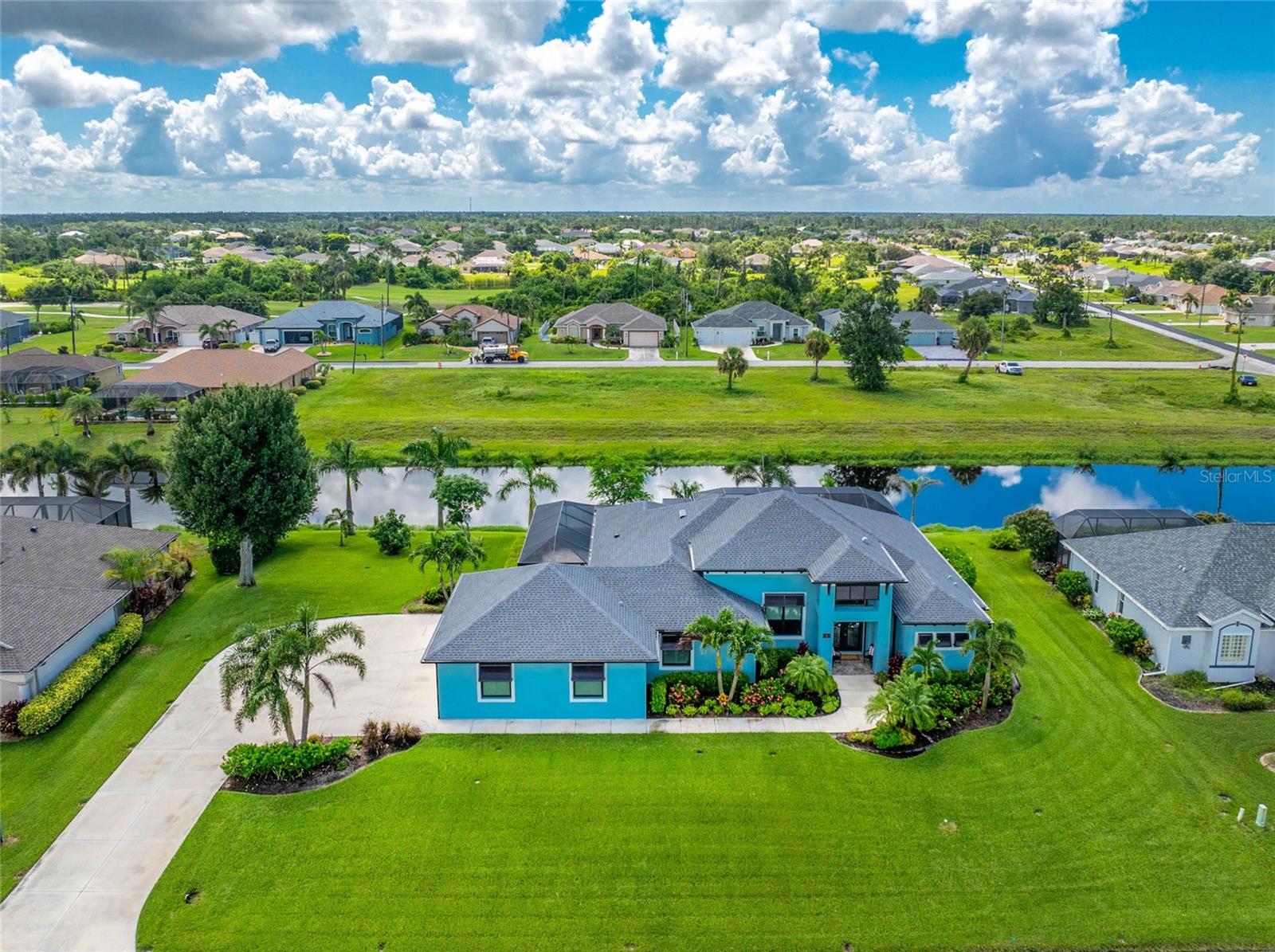 Discover the Lifestyle You’ve Been Dreaming of at this Impeccable 2020 Vantage Built Heated Saltwater Pool Home in Rotonda West! Offering four bedrooms, including two private ensuite-style retreats and an expansive side-entry 3+ car garage, this home was thoughtfully designed for comfort, convenience, and modern living. Double glass doors beneath a portico entry open to a home accented by an oversized driveway, 2022 roof, decorative Bahama shutters, transom window, and an abundance of tropical inspired landscaping. Step inside and be impressed by the sleek, light-filled interior. The grand foyer with its chandelier sets the tone, while whitewashed luxury vinyl flooring and tile throughout, striking tray and beamed ceilings, and contrasting paint accents create a true sense of modern luxury. The triple set of pocketing sliders in the great room offers panoramic views of the pool and canal beyond while also providing you with an enormous amount of entertaining space. The formal dining area and kitchen open seamlessly to the great room, creating an ideal space for entertaining. The kitchen has white shaker-style soft-close cabinets, a large island with blue base cabinetry and breakfast bar, granite countertops, double wall ovens, a built-in wine rack, glass tile backsplash, and a spacious walk-in pantry with motion-sensor lighting. The main primary ensuite offers a true retreat with tray ceilings, sliding glass doors to the pool, a massive walk-in closet, dual vanities, a fully tiled walk-in shower with multiple shower heads and custom niches, and a relaxing soaking tub. The second ensuite bedroom also impresses with two sets of sliding doors leading to outdoor spaces, a tray ceiling, walk-in closet, and a bathroom that doubles as a pool bath with a spacious walk-in shower. The remaining two bedrooms, one currently being used as a home office, provide ample space for family and friends. Built-in cabinets in the oversized laundry room make organization simple and convenient. Step outside to your own tropical retreat on the pavered, screened lanai featuring an outdoor prep area with ceiling fans, granite countertops, a stainless steel refrigerator, and storage drawers. Enjoy the convenience of an outdoor shower and a sparkling saltwater heated pool with a sunshelf, all overlooking the canal. After a day on the golf course or reeling in your fresh catch, relax in the pool or fire up the grill for a perfect evening of outdoor dining. Additional upgrades include remote-controlled roll-down aluminum shutters protecting the front doors and two bedroom sliders, a roll-down Kevlar screen over the covered lanai to protect that area and the sliding doors in the great room, and impact-rated windows offering peace of mind for storm protection. The garage offers a workshop area with electricity, prewiring and a transfer switch for a generator, and features plantation shutters. Living in Rotonda West, you can enjoy five premier golf courses, scenic walking and biking trails, peaceful lakes and canals, and easy access to beaches, marinas, shopping, and dining. Spend your days just minutes from Englewood Beach, Boca Grande, the Atlanta Braves spring training facility, the vibrant new Wellen Park, and Historic Dearborn Street, home to a weekly seasonal Farmer’s Market and year-round community events. Life at 35 Medalist Circle puts it all within reach, schedule your private tour today.