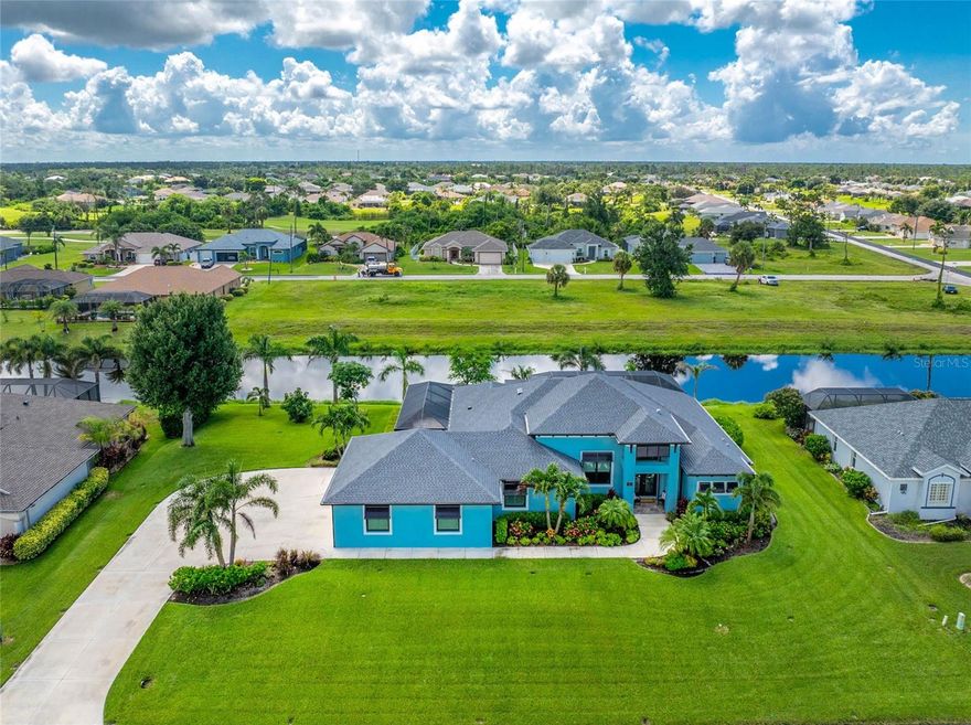 Discover the Lifestyle You’ve Been Dreaming of at this Impeccable 2020 Vantage Built Heated Saltwater Pool Home in Rotonda West! Offering four bedrooms, including two private ensuite-style retreats and an expansive side-entry 3+ car garage, this home was thoughtfully designed for comfort, convenience, and modern living. Double glass doors beneath a portico entry open to a home accented by an oversized driveway, 2022 roof, decorative Bahama shutters, transom window, and an abundance of tropical inspired landscaping. Step inside and be impressed by the sleek, light-filled interior. The grand foyer with its chandelier sets the tone, while whitewashed luxury vinyl flooring and tile throughout, striking tray and beamed ceilings, and contrasting paint accents create a true sense of modern luxury. The triple set of pocketing sliders in the great room offers panoramic views of the pool and canal beyond while also providing you with an enormous amount of entertaining space. The formal dining area and kitchen open seamlessly to the great room, creating an ideal space for entertaining. The kitchen has white shaker-style soft-close cabinets, a large island with blue base cabinetry and breakfast bar, granite countertops, double wall ovens, a built-in wine rack, glass tile backsplash, and a spacious walk-in pantry with motion-sensor lighting. The main primary ensuite offers a true retreat with tray ceilings, sliding glass doors to the pool, a massive walk-in closet, dual vanities, a fully tiled walk-in shower with multiple shower heads and custom niches, and a relaxing soaking tub. The second ensuite bedroom also impresses with two sets of sliding doors leading to outdoor spaces, a tray ceiling, walk-in closet, and a bathroom that doubles as a pool bath with a spacious walk-in shower. The remaining two bedrooms, one currently being used as a home office, provide ample space for family and friends. Built-in cabinets in the oversized laundry room make organization simple and convenient. Step outside to your own tropical retreat on the pavered, screened lanai featuring an outdoor prep area with ceiling fans, granite countertops, a stainless steel refrigerator, and storage drawers. Enjoy the convenience of an outdoor shower and a sparkling saltwater heated pool with a sunshelf, all overlooking the canal. After a day on the golf course or reeling in your fresh catch, relax in the pool or fire up the grill for a perfect evening of outdoor dining. Additional upgrades include remote-controlled roll-down aluminum shutters protecting the front doors and two bedroom sliders, a roll-down Kevlar screen over the covered lanai to protect that area and the sliding doors in the great room, and impact-rated windows offering peace of mind for storm protection. The garage offers a workshop area with electricity, prewiring and a transfer switch for a generator, and features plantation shutters. Living in Rotonda West, you can enjoy five premier golf courses, scenic walking and biking trails, peaceful lakes and canals, and easy access to beaches, marinas, shopping, and dining. Spend your days just minutes from Englewood Beach, Boca Grande, the Atlanta Braves spring training facility, the vibrant new Wellen Park, and Historic Dearborn Street, home to a weekly seasonal Farmer’s Market and year-round community events. Life at 35 Medalist Circle puts it all within reach, schedule your private tour today.