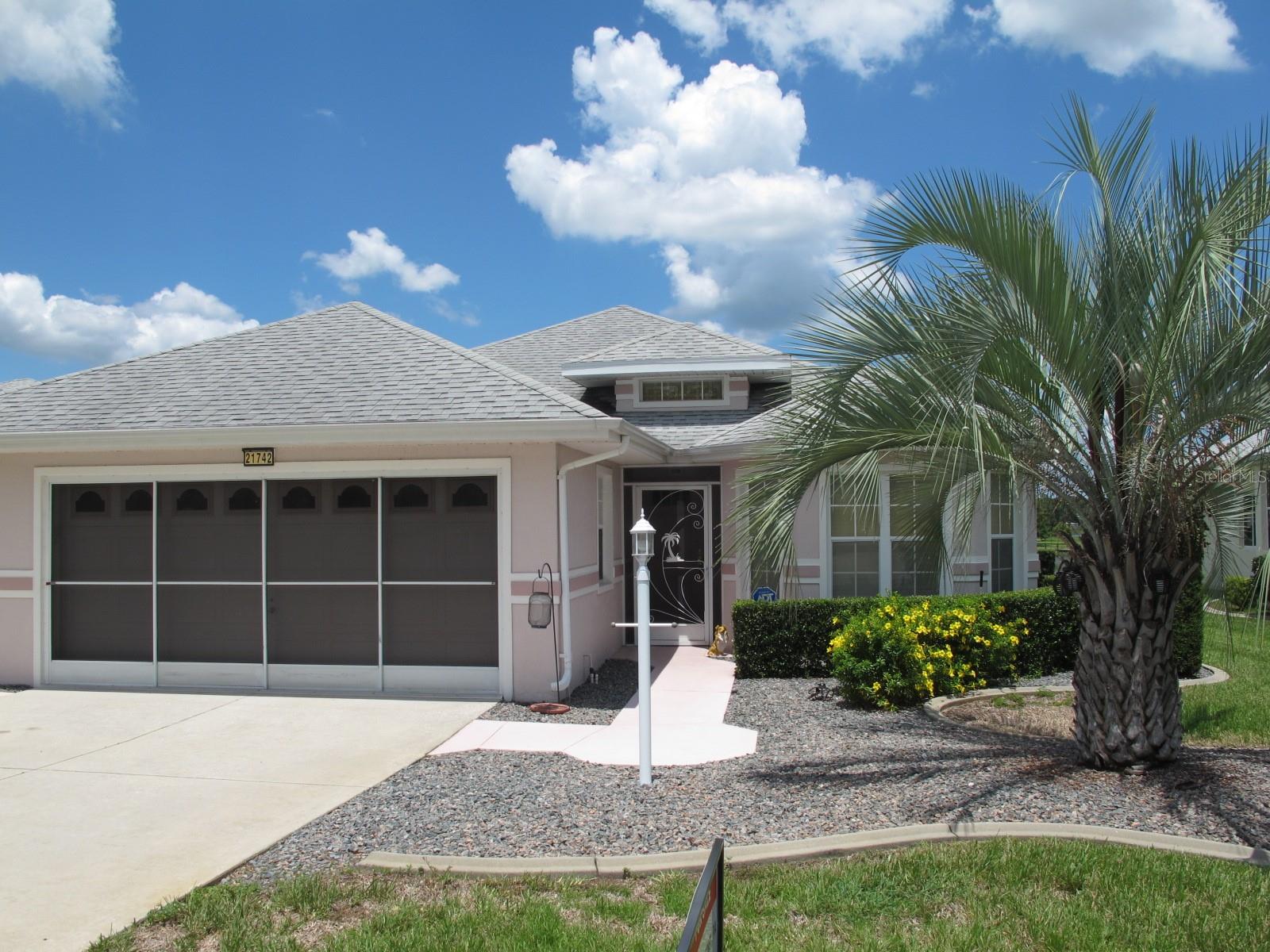 Beautiful lake view in Royal Highlands with modified Opal model. Fully enclosed Florida room with A/C, large bay windows and Plantation shutters. Large kitchen has solid wood cabinets, breakfast bar, pull out drawers, pantry, and separate eating space. Great room extends almost the length of the house and includes dining area, all with wood style flooring. The master bedroom has an extra large walk in closet! The Master Bath has dual sinks with separate tub and walk-in shower. The laundry room has extra storage, a sink, and a desk. The outdoor patio is screened and overlooks the lake. Additional paved patio for barbecuing. Large garage includes storage, pull down stairs, electric opener and sliding screen. Royal Highlands is a gated community with both indoor and outdoor swimming polls, tennis courts, 18 hole golf course, restaurant, recreation center and fitness Center. Easy turnpike access to either Leesburg or Orlando.