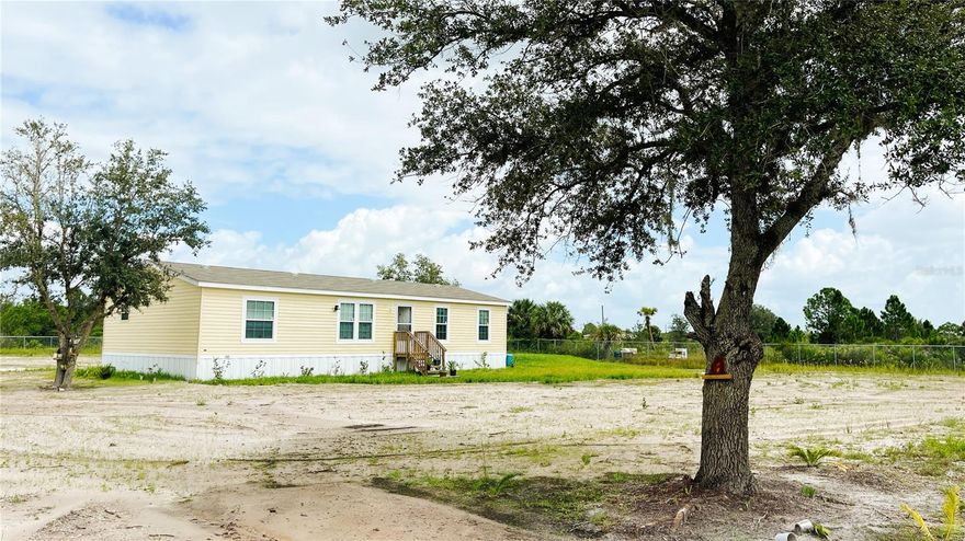 Welcome to your private sanctuary on 2.5 acres!
2023 manufactured home -  vacant- 3 bedrooms/2 baths. Photos were taken prior to removing furnishings. Unfurnished now.
New appliances (washer/dryer do not convey). Owner added cabin/shed (12x24) can be used for storage or bedroom (not currently connected to utilities). See MLS listing attachment for cabin layout. Owner added the following enhancements; septic tank, additional tank and well, pond, 6' galvanized chain link fence, leveling of land, woods clearing, road inside gate, bridge outside gate, cabin/shed and anchor for shed. Enjoy the owner planted fruit trees, pomegranate--mango, apple, avocado, oranges, grapefruit, fig, soursop and see beauty and peaches. Click on TOUR button to see beauty and potential of this unique property. Come visit soon!