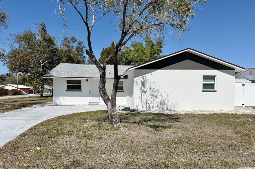 Completely renovated 4-bedroom, 3-bathroom home located in the heart of Bradenton! This move-in ready property features a modern open concept floor plan with stunning large format porcelain tile flooring throughout and abundant natural light.

The fully updated kitchen showcases sleek quartz countertops, custom wood cabinetry, stainless steel appliances, designer pendant lighting, and a spacious island perfect for entertaining. The open living and dining areas flow seamlessly to the backyard through sliding glass doors, creating ideal indoor and outdoor living.

All three bathrooms have been beautifully remodeled with contemporary finishes, including floor-to-ceiling tiled walk-in showers, modern vanities, upgraded fixtures, and stylish lighting.

Exterior features include a fresh modern façade, extended paver patio areas, and a fenced backyard offering privacy and space to relax or entertain. The large lot provides ample room for pets, play, or future additions.

Conveniently located near shopping, dining, schools, and just a short drive to Gulf beaches.
