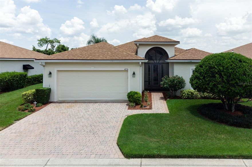 They say location is everything in real estate and this home has it. Positioned on the fairway of Lake Ashton Golf Club's East Course's 14th hole, this home has direct views of a large pond and nature preserve. In addition, this home is a short distance from Lake Ashton's main clubhouse with it many indoor and onsite amenities. It just doesn't get any better. This must-see and ready-to-move-in 2 bedroom with den and 2 bath BISCAYNE floor plan home has many upgrades and superior retrofits. A new roof was installed in 2020, the A/C is newer, and all the windows were replaced in 2018 with vinyl double-hung low e insulated glass easy-clean units. From the moment of arrival, the curb appeal is evident. The quality landscaping encompasses the entire home and is irrigated by an automatic sprinkler system that is fed from a dedicated irrigation meter, a real money saver. The paver drive and walk lead to the screened and covered front entry. This screening adds a level of protection while also making cross-ventilation a "breeze". Once inside, the vaulted foyer provides a bright welcome derived from the great natural light that comes from the arched over-the-transom window, full-length glass front door, and sidelights. The foyer is also where the access to the second bedroom, guest linen closet, and guest bath is located. The handy pocket door can be used to isolate this guest suite portion of the home, a feature that visitors will love. The central core is the combination living and dining room. This large flexible space makes entertaining most doable and is enhanced by the crown molding and ceiling fan. The south wing holds the 2 bedrooms and den. A double door can be used to close off the den when needed for extra sleeping quarters. The master suite is at the rear of the home and includes a large bedroom and a master bath with 2 walk-in closets, a linen closet, a mirrored closet door, a corner garden tub, dual vanities with sinks, a stall shower, and an elongated toilet. The north wing holds the dinette, kitchen, utility room, and attached 2-car garage. The dinette is the perfect place for that morning coffee while enjoying the fantastic view. The kitchen has granite counters, some newer appliances, a tile backsplash, and upgraded plumbing fixtures. A handy snack bar, closet pantry, a solar tube for natural light, and crown molding enhance the kitchen. The utility room doubles as the mud room for the attached garage but also holds the washer and dryer that stay for the new owners. The utility room has a built-in desk area with extra cabinetry, making for a great mini-office. The current owner has established a workshop area in the garage. The garage has new epoxy floor paint, extra cabinetry, a pull-down attic access ladder, and hang-down storage. Across the rear of the home is the fully enclosed covered lanai. The slider windows (which can be easily removed) have screens. This 10x24 lanai has ceramic tile flooring, ceiling fans, and a summer kitchen with a "Jenn Air" grill and bar refrigerator. This lanai area is bonus space as its dimensions are not included in this home's stated square footage. Access to the lanai is through a double slider in the dinette and a triple slider in the living room. A reverse osmosis system supplies drinking water and feeds the refrigerator's ice and water dispenser. Ceiling fans are in most rooms. Window treatments stay. Furnishings are available. Pride of ownership is most evident. THIS IS A MUST SEE!