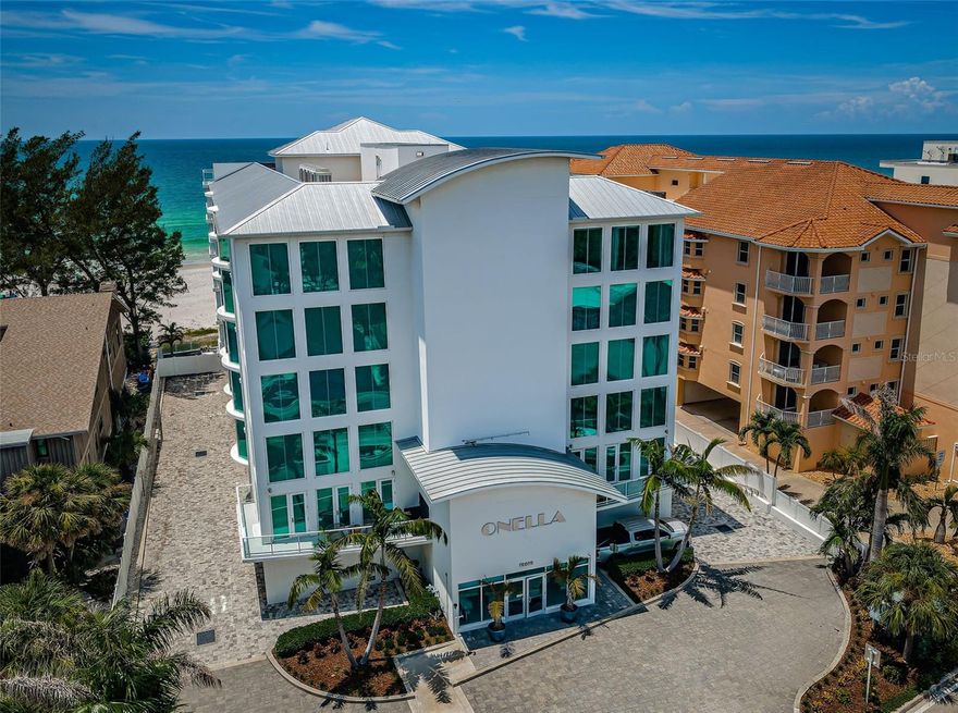 DAZZLING CONTEMPORARY LUXURY WITH UNFORGETTABLE DIRECT WEST-FACING VIEWS OF THE GULF AND BEACH!  Located in the highly-acclaimed Onella luxury condominium community, this 4 bedroom 3 ½ bath residence boast gorgeous finishes and spectacular views.  Step into an impressive great room that transitions to a superb 37ft-wide covered beachfront balcony.  With sweeping panoramic vistas of the azure waters of the Gulf, this mammoth 570sqft balcony is perfect for entertaining friends, family and large gatherings.  The spacious open-concept gourmet chef’s kitchen boasts elegant quartz surfaces, coastal white shaker style cabinetry, Wolf/Subzero/Miele appliances, gas cooking, a huge island prep center, sizable breakfast bar, pantry, and beverage center with separate wine chiller.  Overlooking the Gulf, the exceptional owner’s suite features private access to the beachfront balcony and an exquisite custom designer closet system with center island dresser and extravagant built-ins.  The owner’s bath is a lavish retreat – with resplendent dual vanities, pampering stand-alone soaking tub, and a grand, beautifully-tiled multi-fixture glass rainshower enclosure.  Second bedroom suite is large, has fine custom finishes, and a wonderful full designer bath.  Guest bedrooms three and four are oversized, and are supported by a luxuriously appointed Jack-n-Jill bath. You’ll appreciate the richly-finished laundry facility, generous in-unit storage, and your large private 2-car garage.  The Onella is supported by a fabulous private heated pool and spa with plenty of lounging space, and separate areas for outdoor dining.  The community provides private gated access to a brilliant white powder-soft sand beach and the tranquil waters of the Gulf.  You’ll relish the miles of sandy shoreline, incredible red-orange sunsets, and moonlit nights that literally light up the beach.  Conveniently located near shopping, dining and entertaining, this is a perfect location to enjoy all that beachfront living has to offer.  Dimensions are estimates, buyer to verify.