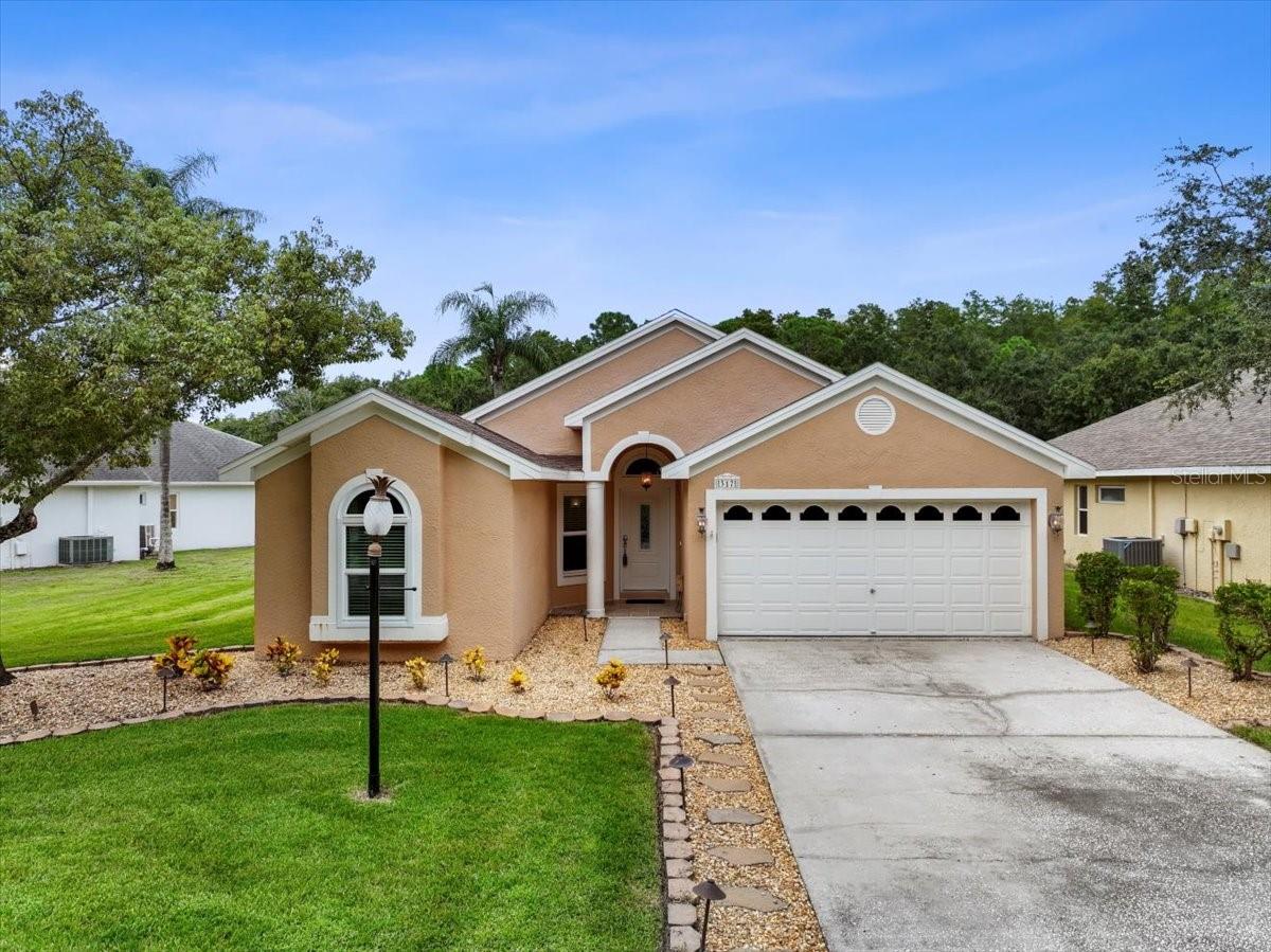 Set between conservation views in the front and a pond with a wooded backdrop in the back, this beautifully updated three-bedroom, two-bath pool home boasts a serene natural setting and a convenient Oldsmar location. The charming front portico porch and subzero landscaping create a warm welcome and set the stage for the thoughtful design you’ll find throughout. Step inside the front foyer to the gorgeous, engineered hardwood floors that flow seamlessly into the dining and living rooms. The open-concept layout is enhanced by vaulted ceilings, wide doorways, neutral tones, and numerous large windows and bay windows that fill the space with abundant natural light. Whether you’re hosting a dinner party, enjoying a quiet evening in, or taking in views of the pool and pond, the home’s layout balances style with comfort. At the heart of the home, the updated kitchen features all-wood custom cabinetry with convenient pull-out drawers, solid surface countertops, stainless steel appliances, and a center island for prep and storage. A pantry provides ample organization, while a raised breakfast bar with seating connects to the living and dining areas—ideal for entertaining and conversations with the cook. The breakfast nook is set into a bay window, making it a cozy spot for quick meals or your morning coffee. Currently arranged as a dining room, the family room provides flexible living space with views of the pool and pond and access to the screened-in pool area. The primary bedroom is generously sized, with a vaulted ceiling, two walk-in closets, and a bay window overlooking the pool and pond. The ensuite bathroom features a jetted soaking tub, walk-in shower, private water closet, and travertine tile accents. The split-bedroom floor plan provides privacy and convenience, with two additional bedrooms at the front of the home. The second bedroom includes a recessed window with conservation views, while both secondary bedrooms share a well-appointed bathroom with a tub/shower combination, a stylish vanity, and a linen closet. The utility room with a full-sized washer and dryer offers a convenient garage entry. Enjoy the year-round Florida weather with the comforts of a screened-in pool area complete with a sitting shelf, tranquil water fountain features, and views of the pond and conservation—perfect for entertaining, relaxing, or spending time with family. Other key highlights include HURRICANE IMPACT windows and doors (4/23) for peace of mind and the low-e glass on the windows, along with the energy-efficient radiant barrier insulation, and a solar exhaust fan add energy efficiency and reduced utility costs. Freshly painted interior (8/25) A/C (10/21), and water heater (12/24). X flood zone -no damage or flooding from past hurricanes. Fountains at Cypress Lake community offers natural beauty and an excellent location. Residents are less than half a mile from the local elementary school and enjoy easy access to beaches, parks, shopping, dining, hospitals, and the Tampa International Airport. Come see this exceptional home for yourself. Schedule your private showing today.