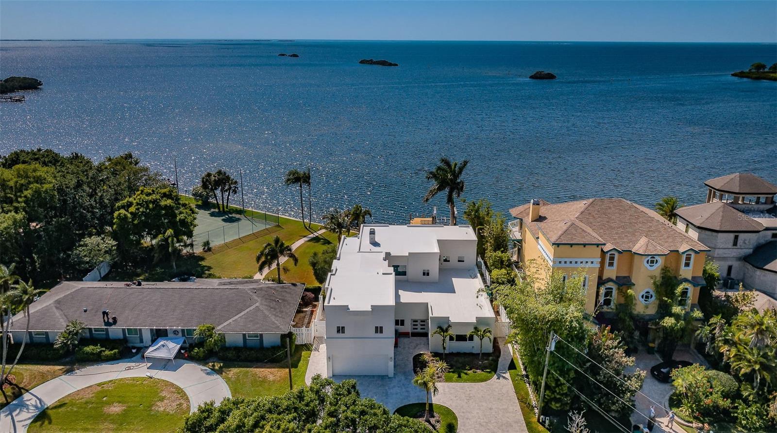 This is an incredibly exceptional home that stands out from the rest! If you love magical sunsets on the water while making special memories with family and friends, this is Your home! An entertainers dream home that has been completely updated to enhance your Gulf Front living experience! The first thing you will notice when entering this outstanding house are the Views and all the Natural light coming from the HUGE New windows! Featuring solid block construction, it is a masterful achievement of concept and design! This contemporary 4,657 square foot, 2-story West facing premiere Gulf front residence has been renovated extensively, with well over a $1,000,000++ invested in updating the house to better emphasize living on the water! Featuring Spectacular sunsets daily, this home showcases exceptional craftsmanship & design to take advantage of cool western breezes and exceptional wide-open views of the Gulf of Mexico! A partial list the improvements completed in 2022/23 included ALL new impact windows and doors throughout! NEW 22 KW whole home backup generator and NEW saltwater pool and spa systems. NEW landscaping, irrigation systems and lighting featuring a new paver driveway. The reconfigured lower level now features a NEW 5th bathroom and New dining room overlooking looking the Gulf of Mexico, and 3 additional bedrooms! You can watch the sunsets in the NEW kitchen featuring NEW appliances, cabinets, and custom granite and tilework! A NEW whole-home water softener and filtration system and a NEW massive walk-in custom pantry help make cooking and entertaining a breeze!! NEW 24X48 Brazilian tile flooring throughout the house. You will stay cool with 2 New HVAC systems featuring Wi-Fi compatibility and humidity control! While entertaining you will not have to worry about running out of ice because you have a NEW free-standing, high-volume icemaker! NEW custom made, Solid Wood Shaker doors and 8-inch trim throughout. Watch the MOST amazing sunsets and the dolphins playing from your Private deck on the second story Master Suite! Featuring a see-through railing system reminiscent of being a on cruise ship… without the rocking! The views keep coming for you in the Master Bathroom featuring a New HUGE 2 head walk-in shower highlighted with custom tile work and a 2-person Spa Two! Two tankless hot water systems supply plenty of hot water for the entire house! Of course, you have 2 NEW designer vanities and custom lighting! Your very spacious Master suite also has a huge walk-in closet with a kitchenet and separate dressing room! The upstairs also hosts 2 additional bedrooms complete with a separate ‘kids’ lounge! The entire interior was retextured and painted to emphasize your views. The exterior was coated was with a waterproof membrane and painted. The existing dock features a 10K pound lift with a remote control! A deepwater channel gives you easy access to the barrier Islands and the Gulf of Mexico! This outstanding home was redesigned to make your living on the water as worry free as possible! Palm Harbor boasts 210-acre Wall Springs Park includes a natural spring, minutes to the Sponge Docks, Pinellas County trail & highly rated restaurants. Minutes from Tampa International Airport.