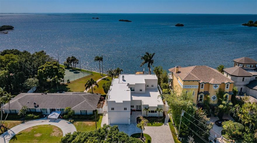 This is an incredibly exceptional home that stands out from the rest! If you love magical sunsets on the water while making special memories with family and friends, this is Your home! An entertainers dream home that has been completely updated to enhance your Gulf Front living experience! The first thing you will notice when entering this outstanding house are the Views and all the Natural light coming from the HUGE New windows! Featuring solid block construction, it is a masterful achievement of concept and design! This contemporary 4,657 square foot, 2-story West facing premiere Gulf front residence has been renovated extensively, with well over a $1,000,000++ invested in updating the house to better emphasize living on the water! Featuring Spectacular sunsets daily, this home showcases exceptional craftsmanship & design to take advantage of cool western breezes and exceptional wide-open views of the Gulf of Mexico! A partial list the improvements completed in 2022/23 included ALL new impact windows and doors throughout! NEW 22 KW whole home backup generator and NEW saltwater pool and spa systems. NEW landscaping, irrigation systems and lighting featuring a new paver driveway. The reconfigured lower level now features a NEW 5th bathroom and New dining room overlooking looking the Gulf of Mexico, and 3 additional bedrooms!  You can watch the sunsets in the NEW kitchen featuring NEW appliances, cabinets, and custom granite and tilework! A NEW whole-home water softener and filtration system and a NEW massive walk-in custom pantry help make cooking and entertaining a breeze!!  NEW 24X48 Brazilian tile flooring throughout the house. You will stay cool with 2 New HVAC systems featuring Wi-Fi compatibility and humidity control! While entertaining you will not have to worry about running out of ice because you have a NEW free-standing, high-volume icemaker! NEW custom made, Solid Wood Shaker doors and 8-inch trim throughout. Watch the MOST amazing sunsets and the dolphins playing from your Private deck on the second story Master Suite! Featuring a see-through railing system reminiscent of being a on cruise ship… without the rocking! The views keep coming for you in the Master Bathroom featuring a New HUGE 2 head walk-in shower highlighted with custom tile work and a 2-person Spa Two! Two tankless hot water systems supply plenty of hot water for the entire house! Of course, you have 2 NEW designer vanities and custom lighting! Your very spacious Master suite also has a huge walk-in closet with a kitchenet and separate dressing room! The upstairs also hosts 2 additional bedrooms complete with a separate ‘kids’ lounge! The entire interior was retextured and painted to emphasize your views. The exterior was coated was with a waterproof membrane and painted. The existing dock features a 10K pound lift with a remote control! A deepwater channel gives you easy access to the barrier Islands and the Gulf of Mexico! This outstanding home was redesigned to make your living on the water as worry free as possible! Palm Harbor boasts 210-acre Wall Springs Park includes a natural spring, minutes to the Sponge Docks, Pinellas County trail & highly rated restaurants. Minutes from Tampa International Airport.