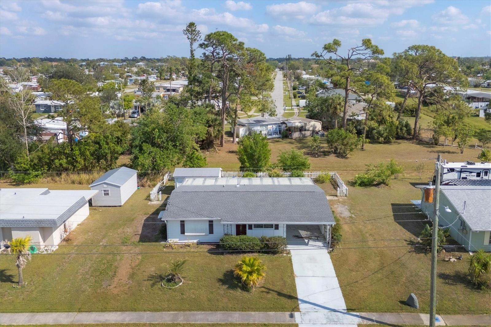 Welcome to your new family home or excellent rental investment opportunity conveniently located in North Port. This cozy 2 Bedroom, 2 Bathroom Home, will have you feeling right at home as you step into the spacious living room which features a vaulted ceiling, coat closet, additional pantry, and built-in shelving for decorative display. As you pass through, you will step into the sizable Kitchen with wrap-around counters and an adjacent private dining area with ample natural lighting. The Master Bedroom, with spacious closet and master bathroom, and Second Bedroom are separated to the other side of the living room along with the 2nd bathroom, to provide privacy from the remainder of the home. Towards the back of the home is the under air, screed-in patio functioning as a Bonus Room for additional living or entertainment or even a potential functioning 3rd Bedroom. Just off of the screened-in patio is the fully functioning Laundry and Utility Room with Washer, Dryer, and additional storage. Stepping outside, your backyard is a beautiful oasis featuring well-manicured landscaping featuring a centrally located mango tree just off of the paver patio with access to your powered, storage shed, and enclosed by picket fence with separation to the neighbors. Lastly, the home is well-updated to last as it is fully equipped with an updated electrical panel (2021), New AC Unit (2023), New Roof (2023), New Hurricane Impact Windows (2023), and Luxury Vinyl Wood Plank Flooring (2023) throughout the home. Perfectly located along Grobe Street, you will have immediate access to US Route 41 (Tamiami Trail) to all the nearby shopping, restaurants, and entertainment the area has to provide. North Port is well situated between Fort Myers & Sarasota for additional access to Marinas, Boating, Fishing, Parks, Playgrounds, Shopping, Restaurants, Baseball Spring Training, Myakka State Preserve, Wildlife, and much more. Come enjoy all that the Southwest Florida Lifestyle has in store for you. Let me help you find Your Piece of Paradise!