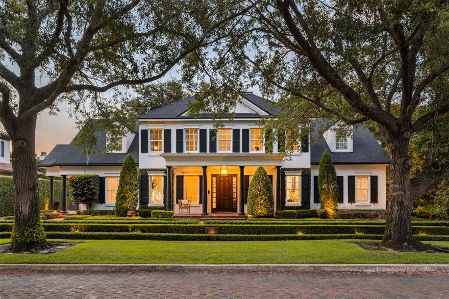 Welcome to Via Palma. This exceptional estate in the heart of the Winter Park Vias has been completely transformed, boasting over $800,000 in luxurious upgrades. A gracious entry foyer sets the tone with marble floors, custom trim work and direct views of the resort-style backyard. The first floor offers elegant formal living and dining spaces, a private study with fireplace, and a spectacular chef’s kitchen featuring an oversized marble island, custom cabinetry, Miele and Sub-Zero appliances, dual dishwashers, a built-in coffee bar, and an adjacent serving bar. The great room showcases custom built-ins, designer lighting, and seamless indoor-outdoor flow to the covered lanai, summer kitchen, lounge space, and saltwater pool. The luxurious first-floor primary suite is a serene retreat with dual dressing rooms and a lavish marble bath featuring a zero-entry double shower, freestanding soaking tub, private laundry room and designer lighting. Upstairs, additional bedrooms each feature en-suite baths and walk-in closets, complemented by a large family room, media lounge and gym with professional flooring. Every detail has been elevated, from European oak and Italian marble floors to Lutron lighting, Sonos audio, Control4 automation, Emtek smart hardware, Nest thermostats, high-efficiency HVAC systems and a backup generator. Outdoor spaces are fully reimagined with a lush landscape design, travertine decking, a putting green and privacy hedging. Near the Winter Park Racquet Club, Kraft Azalea Park, Interlachen Country Club, Phelps Park and YMCA, this home offers a rare opportunity to own a better-than-new custom estate in one of Central Florida’s desirable neighborhoods.