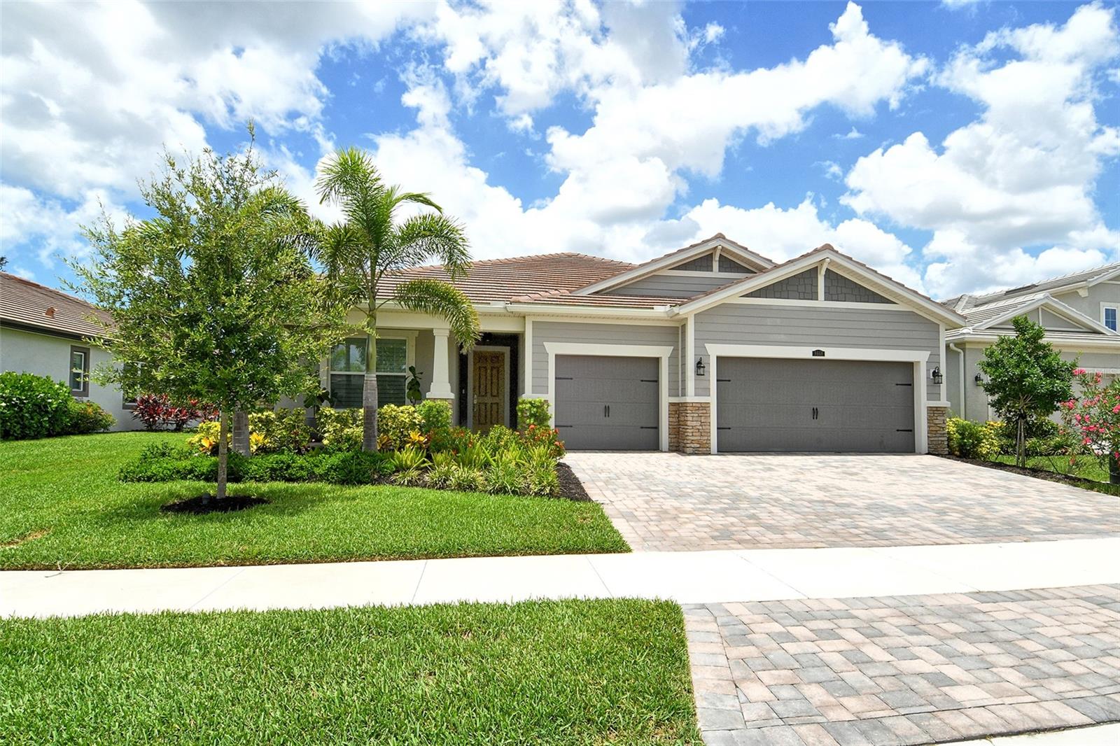 Stunning Coastal-Inspired Retreat in Gated Community! Welcome to this beautifully designed 3-bedroom, 3-bath home with spacious den/office, where style, comfort, and thoughtful upgrades come together in perfect harmony. From the moment you arrive, you’ll be impressed by the tile roof, lush landscaping, and paved driveway leading to a spacious 3-car garage with epoxy floors. Inside, the open floor plan is perfect for entertaining, featuring coastal-cozy colors, luxury vinyl plank flooring, and over-the-top designer lighting throughout. The light and bright kitchen shines with a fabulous pantry and flows effortlessly into the main living areas. The upgraded A/C system ensures year-round comfort. The primary suite is a peaceful escape with a fireplace, amazing walk-in closet, and tranquil preserve views. One of the additional bedrooms features a private en-suite bath and walk-in closet, making it perfect for guests or extended family. A large laundry room, keyless entry, and hurricane shutters add everyday ease. Wine lovers will appreciate the newly built, climate-conscious wine cellar, a unique and elegant addition for entertaining and storage. Step outside to your expansive private outdoor lanai area designed to enjoy a true-Florida lifestyle, with an outdoor kitchen featuring a built-in gas grill and refrigerator with a private putting green, and a fenced, open yard—all designed to enjoy Florida’s gorgeous sunsets in comfort and style. Perfectly located near shopping, dining, world-class beaches, and downtown Sarasota, this one-owner home is part of a gated community with excellent amenities and low HOA fees. This exceptional property truly has it all—luxury, location, and lifestyle. Don’t miss your chance to call it home!