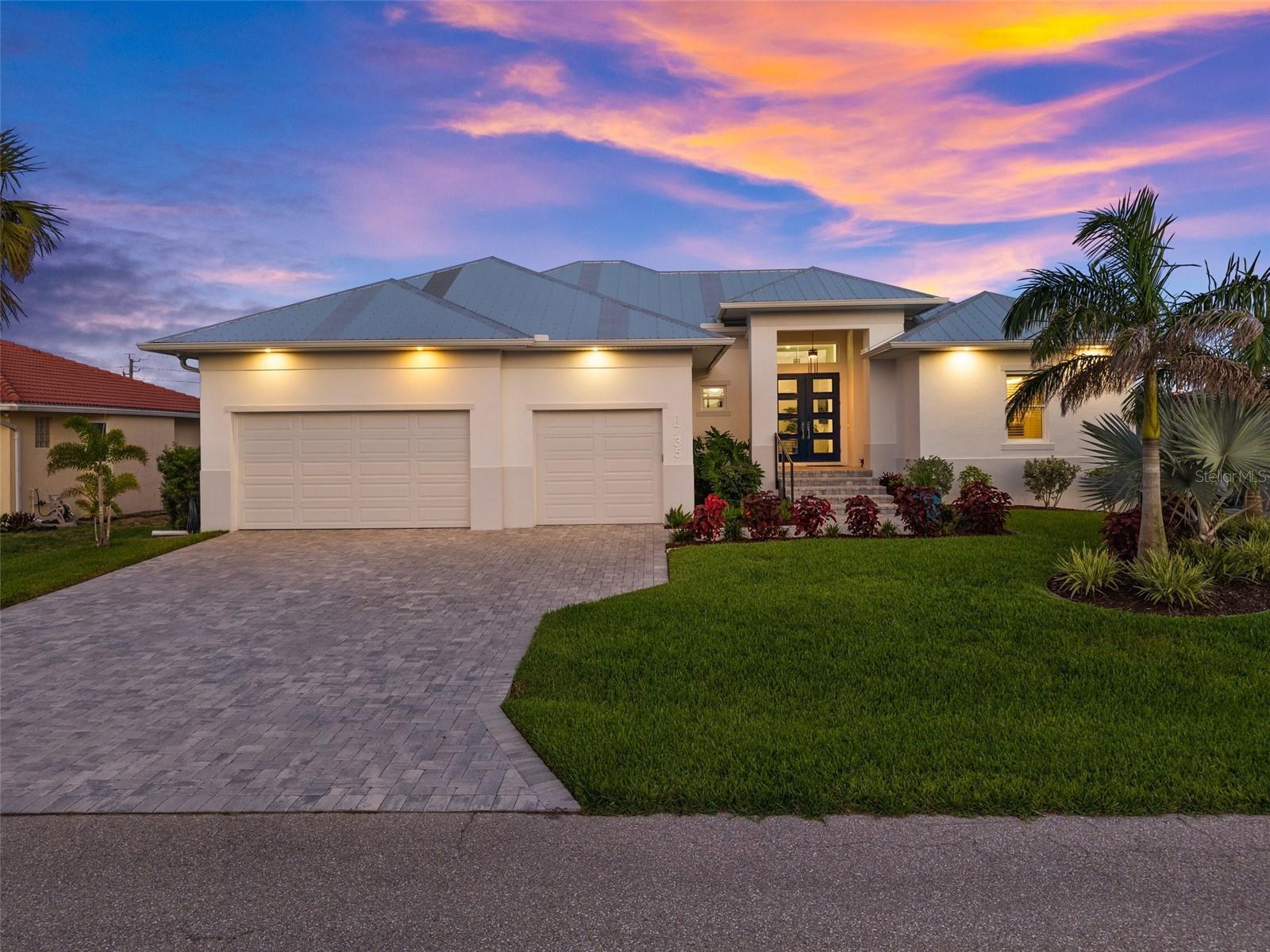 CUSTOM WATERFRONT home built by a local builder for himself located on a cul-de-sac with 80 FEET of water frontage in Punta Gorda Isles. BUILT UP 11.3 FEET FOR HIGHER ELEVATION & NO HOA FEES! CLICK ON THE VIRTUAL TOUR LINK 1 FOR THE VIDEO AND VIRTUAL LINK 2 FOR THE 3D TOUR. Inside, the home offers a spacious open floor plan featuring a formal entryway, expansive great room, and a gourmet kitchen designed to impress. Architectural highlights include soaring tray ceilings in the great room, master suite, and den, a rounded breakfast room with a compass medallion cove ceiling, crown molding, luxury vinyl plank flooring, and custom shiplap feature walls and ceilings. Upgraded finishes such as ball bearing hinges on all doors and a motorized window shade in the den add refined touches throughout. The kitchen is a chef’s dream, boasting gleaming marble countertops, two-tone cabinetry, and high-end GE Professional Series Café appliances, including a built-in convection oven, a Smart Five-in-One wall oven with Advantium Technology, gas range with hood, and RO water filtration system. A large walk-in pantry adds convenience, while the wine/coffee bar provides additional counter space, cabinetry, a prep sink, and a wine refrigerator. Additional features include under-cabinet lighting, breakfast bar seating, and a stylish textured subway tile backsplash. The split-bedroom floor plan provides ultimate privacy. The primary suite is a luxurious retreat with a spa-inspired en-suite bath offering dual split vanities, a private water closet, garden tub, and a tiled walk-in shower, all leading into a generously sized dressing room/closet. One guest suite is privately located behind the kitchen, while the second guest room and den share a beautifully appointed bath with a walk-in shower. The den features paneled walls and a picture window framing serene canal basin views. Step outside to your Florida-style outdoor oasis—the expansive lanai surrounds a heated, saltwater pool and attached spa, all enclosed in a picture-frame pool cage overlooking the wide canal basin. Two covered seating areas and a summer kitchen make entertaining effortless. The fenced backyard leads to a 45-foot extended concrete dock with boat lift—perfect for keeping your vessel at your doorstep and enjoying some of the best boating and fishing in Southwest Florida. Additional features include:
• 3-car attached garage with epoxy flooring and wall-to-wall upper storage
• 3-zone A/C system with UV light filtration
• High-efficiency heat pump water heater
• 500-gallon buried propane tank
• 22KW whole-house generator
• Gas line connections for future fire pit and grill
• Brick paver driveway, lanai, and walkway to dock
• Built above required elevation (over 11 ft) for peace of mind
• Hurricane-rated impact doors & windows plus Kevlar screens for the dining room’s aquarium window
Enjoy all the amenities that Punta Gorda has to offer, such as biking, fishing, boating, dining, live entertainment, and much more! Close to Fisherman's Village, Ponce De Leon Park, Gilcrest Park, and Historical Downtown Punta Gorda. Also, minutes to award-winning beaches such as Englewood Beach, Manasota Key & Stump Pass, to name a few!! Schedule your private tour today—this is your chance to experience elegant waterfront living at its finest.