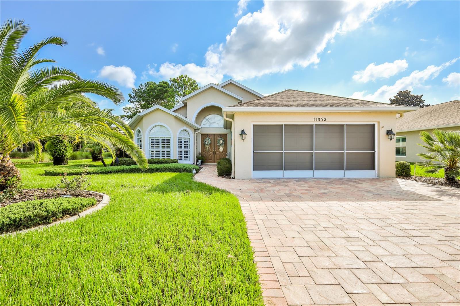 Discover comfort and style in this beautifully updated 3-bedroom, 2-bathroom 'Patio Home' featuring a desirable split-bedroom floor plan and thoughtful upgrades throughout. Nestled on a beautifully landscaped lot with no rear neighbors—just a peaceful retention area—you'll enjoy ultimate privacy and stunning nature views.
The home welcomes you with a paver driveway and walkway leading to elegant double front doors. Step inside to find vaulted ceilings and luxury wood look laminate plank flooring in the main living areas.
The updated kitchen is a showstopper, complete with stainless steel appliances, wood cabinetry, gorgeous countertops, a large single-basin stainless steel sink, under cabinet lighting, breakfast bar, and a cozy eat-in nook with a generous pantry. The inside laundry room adds convenience with extra shelving for storage. The formal living room offers flexible space and could easily function as a formal dining room.
The spacious primary suite features dual closets and a fully updated en suite bathroom with granite counters, dual sinks, and a luxurious snail-style walk-in shower. Two additional bedrooms share a second fully updated bathroom with granite top vanity.
Enjoy year-round living in the enclosed lanai that spans the rear of the home, featuring paver flooring, a ceiling fan, and expansive views of the lush garden and open green space. The lanai opens directly to the family room, creating a seamless indoor-outdoor living experience. Step outside to a paver patio surrounded by beautifully manicured gardens—perfect for entertaining or relaxing in tranquility. Roof 2025. HVAC 2015. Water softener. This 'Patio home' includes lawn maintenance, exterior paint, bush trimming in front, irrigation, cable, internet and more. The Wellington is 55+ guard gated, deed-restricted community, featuring a community pool, clubhouse, bar and restaurant, tennis, bocce, pickleball, billiards, cards, arts, fitness room and more!
Don't miss your chance to own this move-in-ready home that truly has it all!