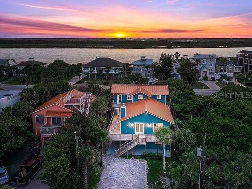 Renovated from top to bottom with granite counter surfaces, white cabinets and stainless appliances.  Center kitchen island has a flat top cook stove.  Subway tile back splash. All in a coastal light taupe.  Ocean views and River views  of the non-driving south beach area of the New Smyrna Beach.  Open floor plan.  Two fireplaces with one in the living room and another in the master suite on the third floor.  Ground level has a mother-in-law suite with two bedrooms, one bath and kitchenette.  Second floor is the main living with the dining room, kitchen, 2 bedrooms and 1 bath.  Enjoy ocean and river views from the large decks on the east and west side.  Oversized double garage with an entrance from Turtlemound Rd.  The lot is 50x150 from S. Atlantic Ave. to Turtlemound Rd.  JB's Fish Camp, the Canaveral Seashore and a small convenience store all all within walking distance. 3 newer coastal interior/exterior A/C systems installed by The Davis Brothers.  2 homes to the beach walkover.  Plenty of room for a pool.  There is a public park nearby with a basketball court, a tennis/pickle ball court, children's playground along with a dock along the river for fishing. ;Water: City