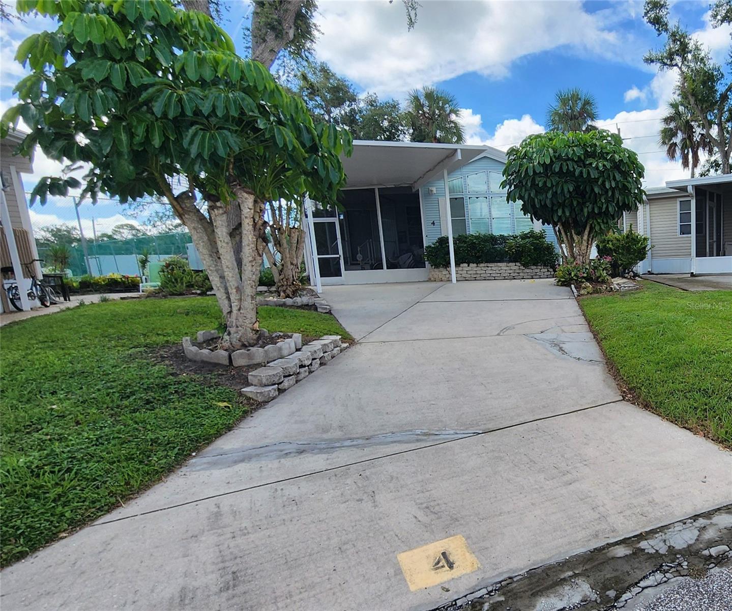 1994 One Bedroom, One Bathroom mobile home in active 55+ community. This furnished home with tennis court views features a screened front porch, mature landscaping, carport and newer central a/c & water heater (2022). This property is being sold in as-is condition with right to inspect. Sugar Creek Villas is a gated community with HOA fees of just $525 per quarter. Fees include water, sewer, trash, grass mowing, basic cable, and internet. Amenities include: Two swimming pools, heated spa, clubhouse, laundry facilities, tennis & shuffleboard courts, fitness room, lending library, workshop, and social activities during the winter season. Home may be rented out for up to six months per calendar year after two years of ownership. Pet friendly, so pack the pooch and start enjoying the Florida sunshine!