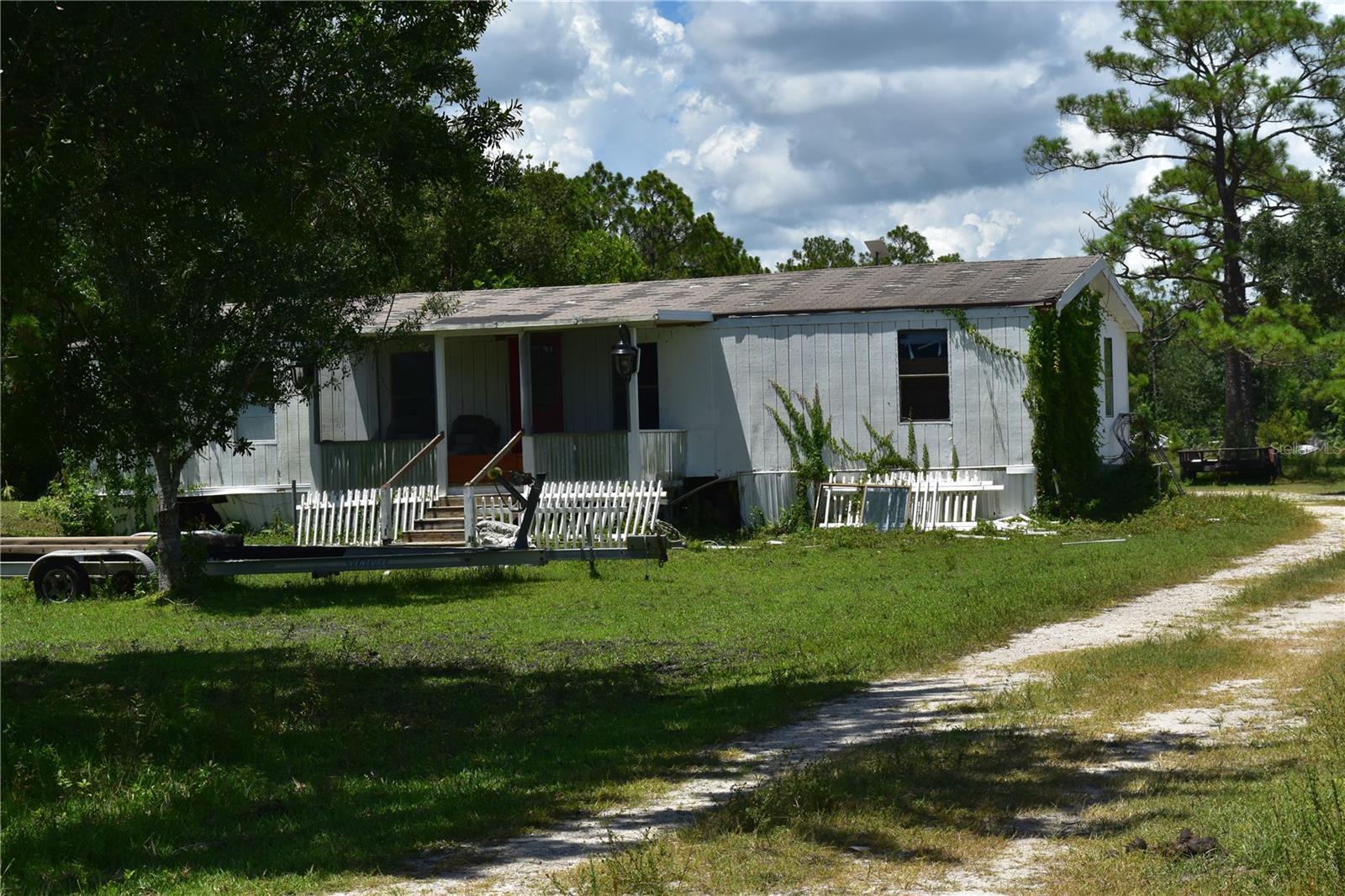 Welcome to this amazing country living opportunity!
ASIS 3-bedroom, 2-bathroom home features split-plan bedrooms and an open floor plan.
Just across from Babcock Ranch. Beautiful 2.5 acres of land, plus a 33'x25'x12 Barn/metal building, and a chicken coop, surrounded by abundant nature, excellent for privacy, and a lot of space to spread out, built and grow. Just over the Charlotte/Lee County Line, and a convenient location to Punta Gorda, Fort Myers, with easy access to the airports.