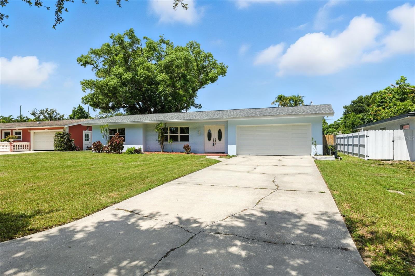 Come claim your slice of paradise! This updated 2 bedroom, 2 full bath, 2 car garage block home is move in ready! Quintessential Florida home close to the beach and all the exciting things to do in Tampa Bay! Situated in a quiet, picturesque neighborhood with lovely mature shade trees in the backyard and plenty of room for a pool. Enjoy lots of natural light with the brand new windows and doors (2022). The spacious living room opens to the dining room and brand NEW kitchen with new soft close cabinets, granite countertops, backsplash, stainless steel appliances and pantry (2023). The pride of ownership is endless with: NEWER ROOF (2019), new luxury vinyl flooring throughout (2023), new baseboards, new fixtures, updated bathrooms, new paint inside and out, new garage door--the list goes on! The layout of the home is ideal for entertaining. Bring your imagination because the massive fenced backyard has a screened in lanai and plenty of room for a pool, gardening, entertaining and furry friends! Sit on your back lanai sipping your morning coffee in the shade of your mature trees before heading off to a day at the beach that is less than 10 minutes away. The large two car garage is perfect for storing all those toys! Close to Award Winning Gulf Beaches, pier, restaurants, shopping. Close to Tampa, St Pete, and a short drive to Tampa International and St Pete Clearwater Airports. Schedule your private tour today! Buyer's agent to verify all room measurements.