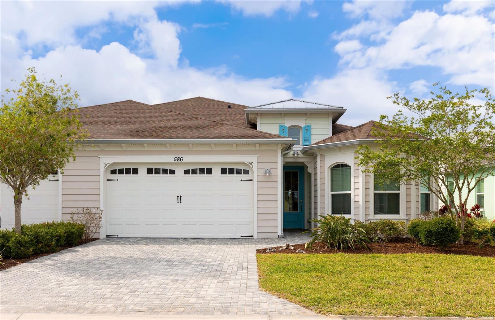 Step right in to your new home in this vibrant 55+ community of Latitude Daytona Beach! This beautiful villa, known as the ''Nevis model,'' boasts 1,862 square feet of living space. The kitchen features brand new, never-before-used stainless steel appliances, a pantry, and ample counter space. You'll appreciate the plank tile flooring throughout, beautifully complemented by fresh carpeting in both the primary suite and the second bedroom. The den can serve as a third bedroom, while an additional room offers options for a game room, bar area, or extra sitting space. A spacious laundry room (with washer and dryer included) and a 2-car garage with epoxy flooring complete this fantastic home. It truly feels brand new! Enjoy your morning coffee or evening cocktails on your lanai as you take in the serene pond view. You'll also have access to exceptional amenities, such as resort-style pools, a fitness center featuring an indoor lap pool, a band shell for weekly live performances, a restaurant and bar, parks, a dog park, and even a private beach club with transportation. If you're ready to embrace your best life, this is the ideal place for you!