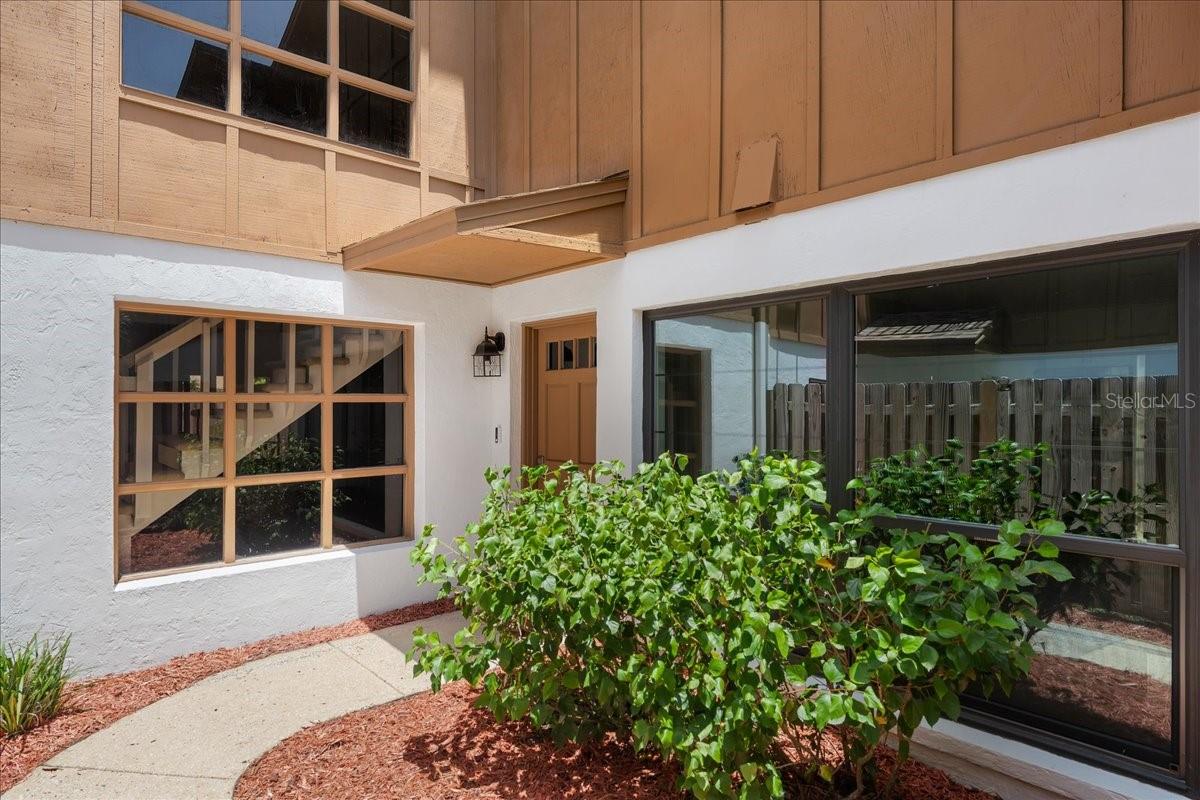 Welcome to your new Ormond Beach oasis, only 10 minutes from Beach St. and the shores of Beautiful Ormond Beach. This fully upgraded and remodeled 3 bedroom, 2 1/2 bathroom townhome truly has it all from modern, luxurious detail to extra living space for any living situation. The entry is private and fenced-in for extra security when bringing groceries up your inviting stoop, and you have a large driveway plus a spacious two-car garage with epoxy coated flooring for all of your needs. Upon entry, you’re greeted with new luxury-style laminate flooring and tons of natural light with floor-to-ceiling windows in both the kitchen, to your right and your living room, to your left. The kitchen is filled with stylish, modern decor with white shaker cabinets, quartz countertops and upgraded stainless steel appliances in top-tier condition. There’s a lovely eating space in the kitchen right next to your huge window where you can enjoy a morning cup of coffee while reading a book or checking emails. Right off the kitchen is a large pantry and your convenient laundry closet with high-end washer and dryers. You can find your way right into your separate dining room, private but connected to the huge living room where your gorgeous stone wood-burning fireplace sits, ready for cozy evenings and hot chocolate or a nightcap. Your primary bedroom can be found on the first floor as well with lovely French doors opening to your back patio and a large walk-in closet and upgraded en-suite bathroom. Up the beautiful swirling staircase framed with floor to ceiling windows you can find an additional living space in the loft, and your two additional bedrooms (one with a massive walk-in-closet) connected by a Jack and Jill bathroom with a bathtub/shower combo, also recently renovated. Renovations in 2023 include a NEW ROOF, NEW WINDOWS, NEW GUTTERS, NEW HVAC, NEW GARAGE DOOR, NEW FLOORING, NEW PAINT, NEW INSULATION, NEW ELECTRICAL WIRING, NEW CEILING FANS, NEW KITCHEN WITH SS APPLIANCES AND QUARTZ COUNTERTOPS AND ALL NEW BATHROOMS. Perfect Florida oasis situated close to restaurants, schools, shopping, parks, and most importantly… Central Florida’s favorite beaches!