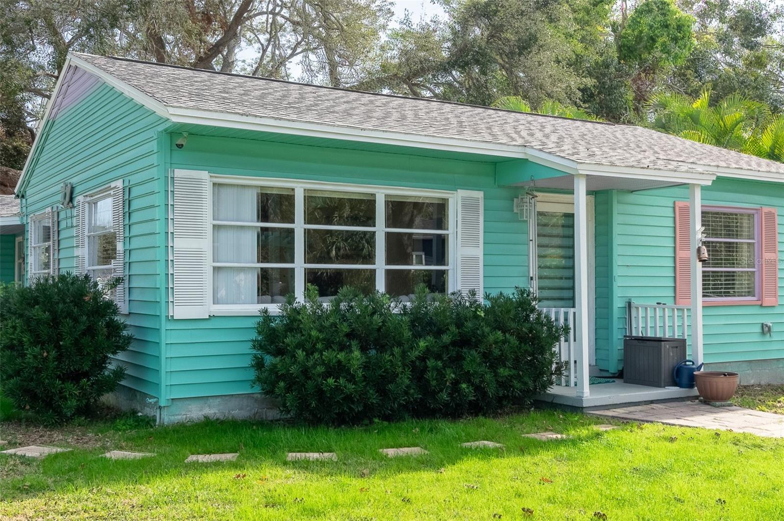 Welcome to your Gulfport retreat! This charming 3-bedroom, 2-bathroom home is situated on a spacious corner lot with a fully fenced yard,
offering both privacy and relaxation. The flexible floor plan includes a mother-in-law suite that divides the home into a 2/1 main area and a 1/1 mother-in-law suite. The suite features its own private entrance, kitchenette, yard, living room, front and back lanai and parking, making it ideal for rental income, extended family, or guest privacy. Double soundproof doors allow you to seamlessly connect the spaces or keep them separate, offering the option to function as a duplex. You could use the property as a short-term rental, choosing when to earn or when to open the entire house for personal enjoyment. Alternatively, live on one side while renting the other long-term, or simply use the additional space to provide your guests with extra privacy. This home has been thoughtfully updated with modern essentials, offering peace of mind for years to come. Recent upgrades include a new roof (2021), HVAC system (2018), mini-split AC (2022), water heater (2017), and new pavers (2021). The screened lanai provides the perfect space to enjoy your morning coffee or unwind in the evenings while overlooking the serene backyard covered by mature oaks. Situated in a prime Gulfport location, this home offers unbeatable convenience. Just steps from the Gulfport Marina, Lions Club, Clam Bayou Park, a kayak launch, and a scenic bike trail connecting to the Pinellas Trail, outdoor adventures are right at your doorstep. A short golf cart or bike ride brings you to Gulfport’s vibrant Waterfront District, where you’ll find eclectic shops, top-rated restaurants, and lively events that capture the heart of this unique community. Plus, you’re only 10 minutes from downtown St. Petersburg and the stunning Gulf beaches. This home had no damage from the recent storms. With its convenient location, thoughtful layout, and modern updates, this home offers the best of Gulfport living. Don’t miss the chance to make it yours, schedule your private showing today!