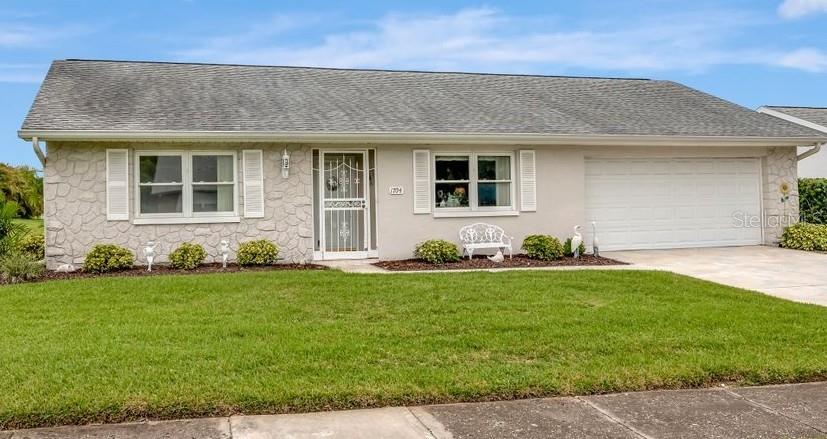 Sellers are motivated to sell this stunning 2/2 home with a 2-car garage in a vibrant 55+ community at an unbelievable price for immediate sale! You will not believe your good fortune in finding such an exquisite home with an extended list of features: top-of-the-line hurricane windows & doors, reinforced hurricane garage door, Florida room with an abundance of windows creating a bright and cheerful ambiance, a large, spacious living room/great room, gorgeous tile and hardwood floors, and a deep well for your irrigation needs. The appliances are newer, including a 2 year old washer and dryer, newer refrigerator and a water softener. Utility tub by washer and dryer. Extra fridge in garage stays! This home sits high and dry on a spacious corner lot; no flood insurance required. It’s just a quick walk to the main clubhouse where “what makes Highland Lakes a premier community in Tampa Bay” activities occur, such as: 3 private 9-hole golf courses (included with your low $164/month association fee), heated pool, spa, tennis courts, pickleball, racquetball, bocce ball and shuffleboard. Highland Lakes also offers fitness classes, water aerobics, floor exercise, yoga, arts, crafts, numerous hobby clubs, bowling leagues, stained glass, ceramics, woodworking, line dance classes and much, much more. Residents are able to enjoy an amazing social life with live events at the main clubhouse as well as the opportunity to enjoy live performances. There is a lakeside lodge on Tarpon Lakes where you will enjoy a second temperature-controlled pool, ping pong, horseshoe pits, fishing pier, boat ramp, pontoon boat excursions as well as a scenic view of the 5-mile long lake. Highland Lakes offers a resort-style lifestyle near highly acclaimed Florida beaches as well as an abundance of restaurants, shopping, parks, entertainment, and medical facilities. The community also offers free RV and boat storage in a secure lot and is completely golf cart-friendly. Your dogs/pets are welcome here. So….don’t miss out. You need to check out this beautiful home today before someone else gets the deal!