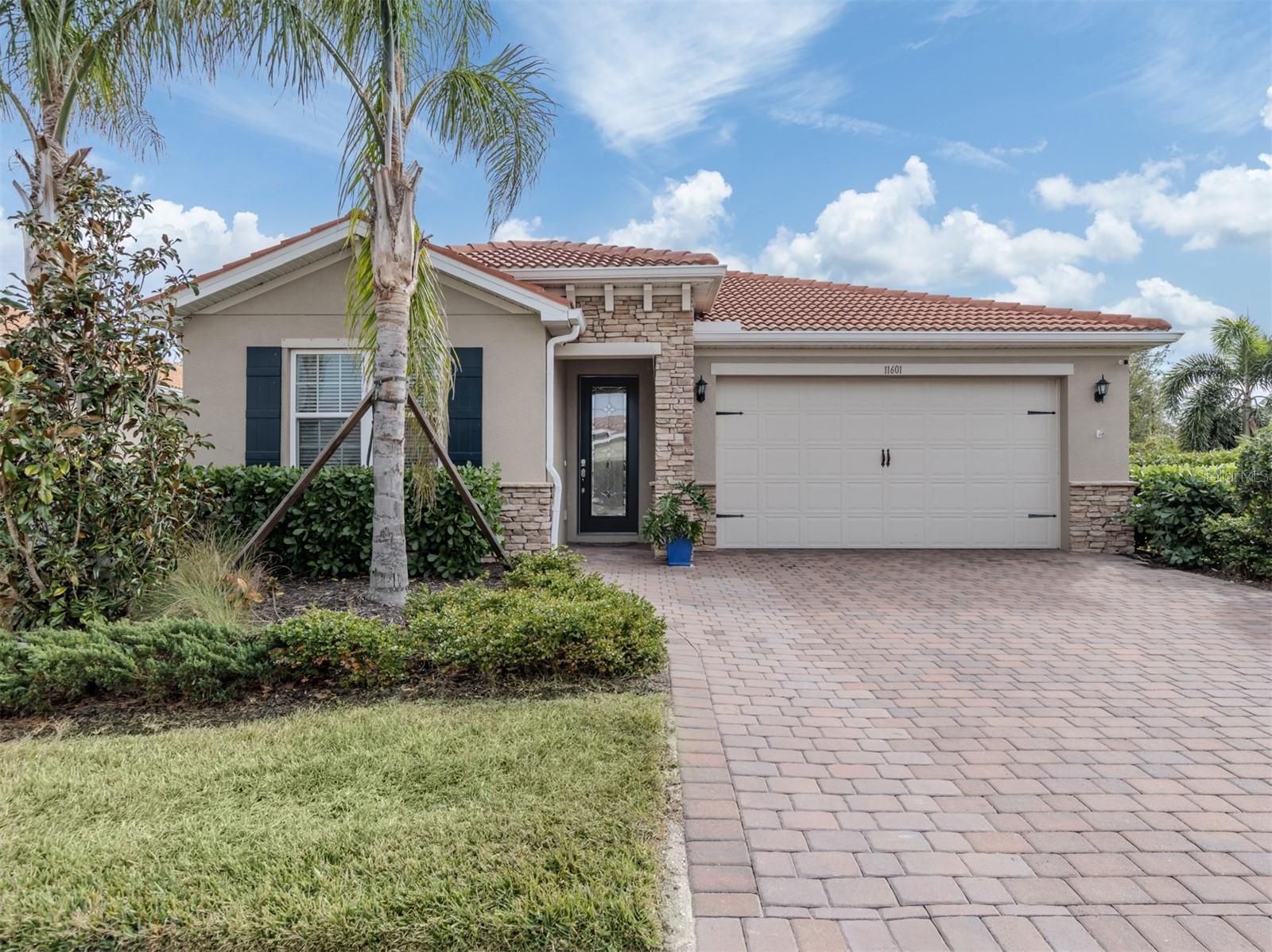 This meticulously cared-for 2 bedroom (with potential 3rd bedroom/den option) D.R. Horton home is an exceptional blend of modern luxury and thoughtful functionality. Built in 2018, this Clifton model sits on a corner lot behind the gates of quiet Caribbean Village. Natural light pours into the entire residence through both the glass front door and glass sliders with southwestern exposure that adorn the back. Ceramic tile flooring is present throughout, including all bedrooms. The split-bedroom layout is ideal for utmost privacy, everyday living and grand entertaining, with an open flow between the great room and chef-inspired kitchen. The kitchen features granite countertops, an expansive kitchen island, under-cabinet lighting, custom backsplash and a walk-in pantry with custom built-in shelves. In addition, the owner has installed custom shelves in every closet throughout the home, including both primary bedroom walk-in closets, second bedroom closet and hallway linen closet. The bonus room offers an added level of versatility, equipped with French doors and enough space to convert into an office, third bedroom, or "man/she" cave. The screened-in lanai exhibits an outdoor sanctuary, with views of the lush Florida landscape, unobstructed by other homes in the community. The new owner of this home will enjoy a large two-car garage with refrigerator, and an extended brick driveway. Caribbean Village is a maintenance-free and gated community with no CDD fee and located in an X Flood zone. Enjoy the community's beautiful heated pool, fitness center, bocce ball courts, and miles of walking trails that border gorgeous lakes. Located just off River Road and Venice Avenue, Caribbean Village offers proximity to both downtown Venice and beaches, as well as I-75. Don't wait for the market to "change", be the change, make an offer today!